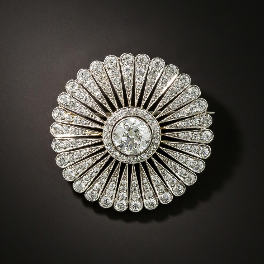 Feast your eyes on one of the finest and most fabulous Edwardian-era (circa early-20th-century) circle brooches on the planet, by none other than Tiffany & Company. An icy-white transitional round brilliant-cut diamond, weighing 1.70 carats, sizzles