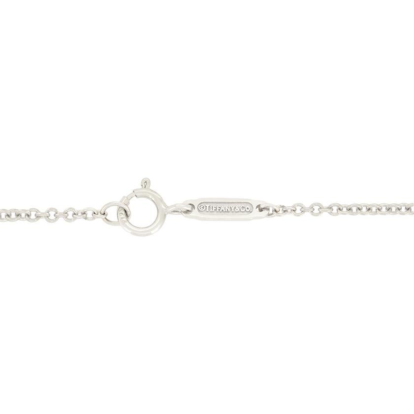 This delightful open heart pendant comes from Tiffany & Co. and their Elsa Peretti collection. Crafted in platinum, the iconic open heart design is adorned with 0.45 carats of round brilliant diamonds, each delicately grain set. The diamonds are of
