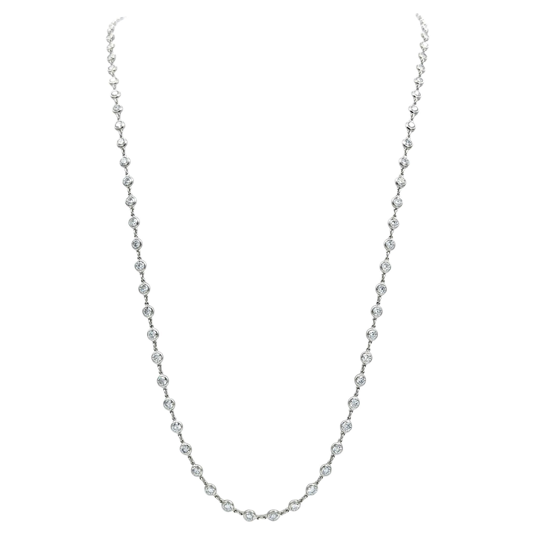 Indulge in the timeless elegance of Tiffany & Co.'s exquisite 'Diamonds by the Yard' necklace, a masterpiece crafted by the renowned designer Elsa Peretti. Set in lustrous platinum, this opulent chain is adorned with 121 round brilliant diamonds,