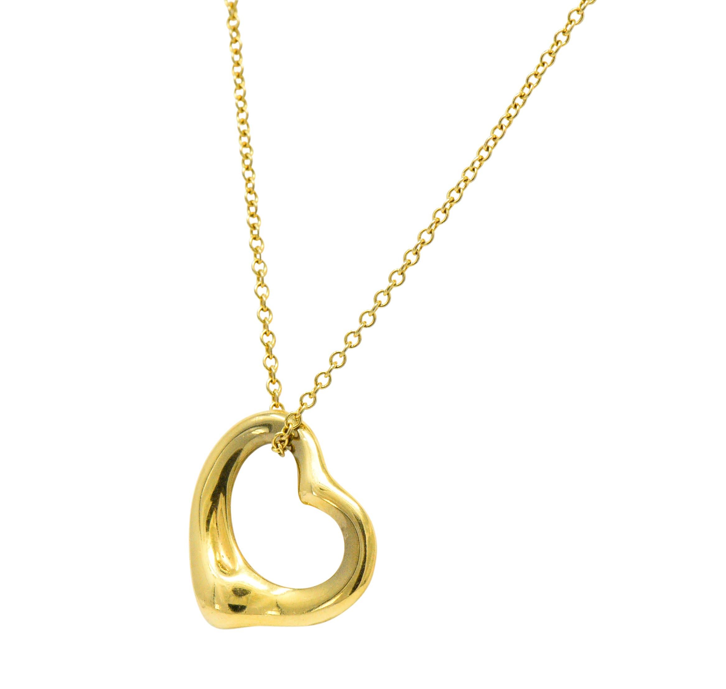 Featuring an 18k gold stylized open heart pendant 

Accompanied by a 16
