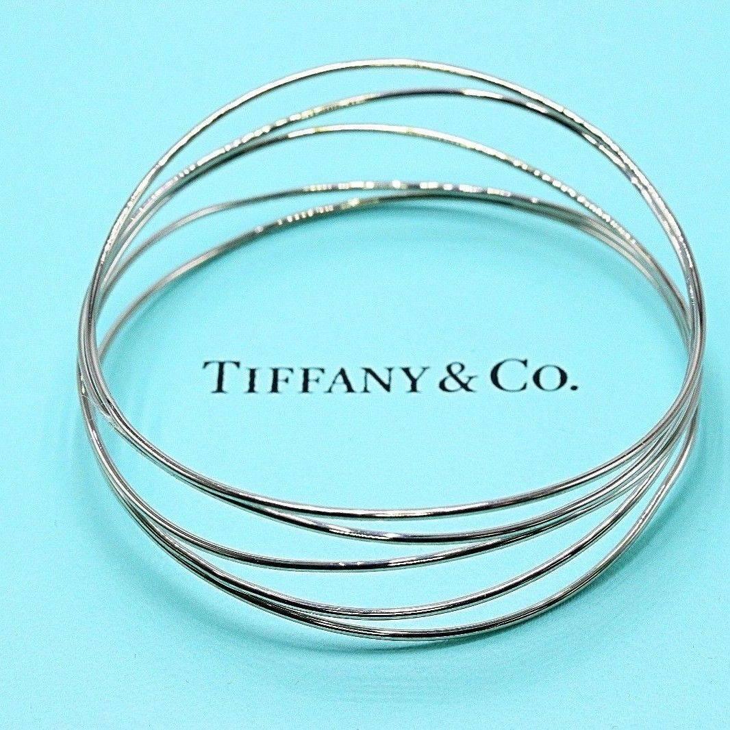 Tiffany & Co.
Style: Elsa Peretti 5 Row Wave Bracelet
Length:  7.75 Inches - 20 MM Wide - 2.50 Inches in Diameter
Metal:  18K White gold
Hallmark:  