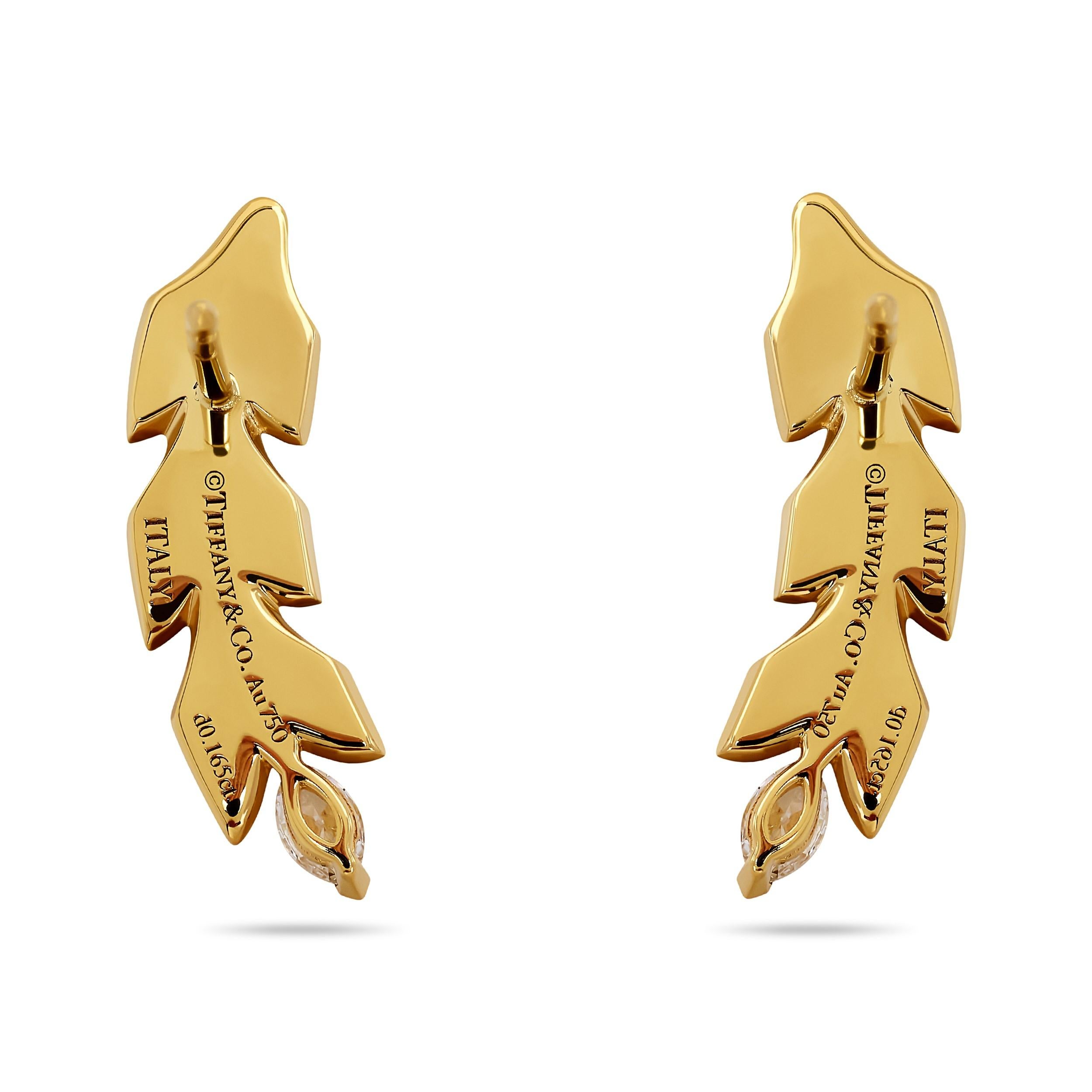 These elegant earrings, designed by the renowned Elsa Peretti, capture the delicate beauty of a leaf. Crafted in 18 karat yellow gold, the leaf shape is accentuated by sparkling diamonds, creating a timeless and sophisticated piece that complements