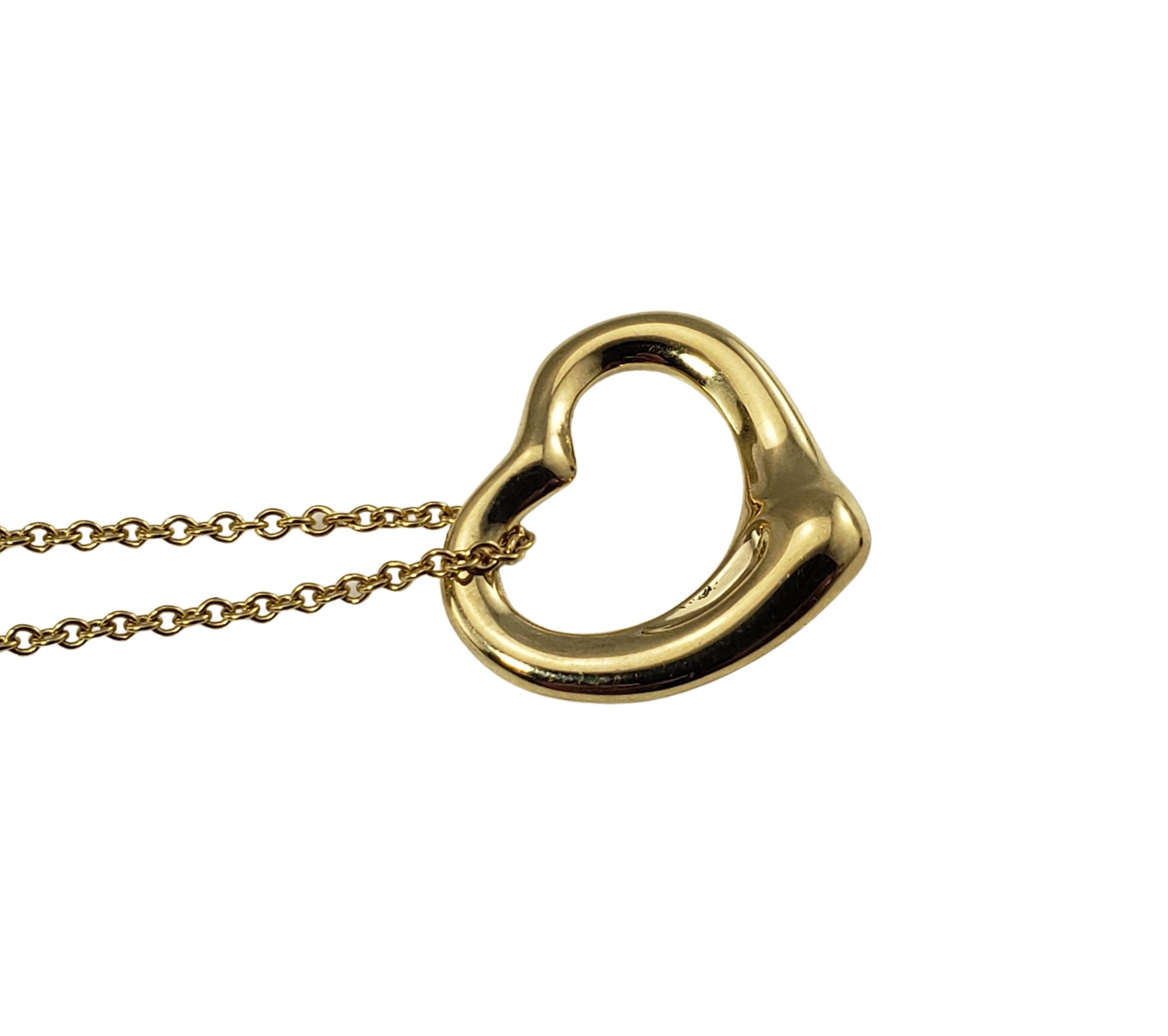 Tiffany & Co. Elsa Peretti 18 Karat Yellow Gold Heart Pendant Necklace-

This lovely open heart by Elsa Peretti for Tiffany & Co. is crafted in beautifully detailed 18K yellow gold and suspends from a classic cable necklace.

Size:   15 mm (heart)
 