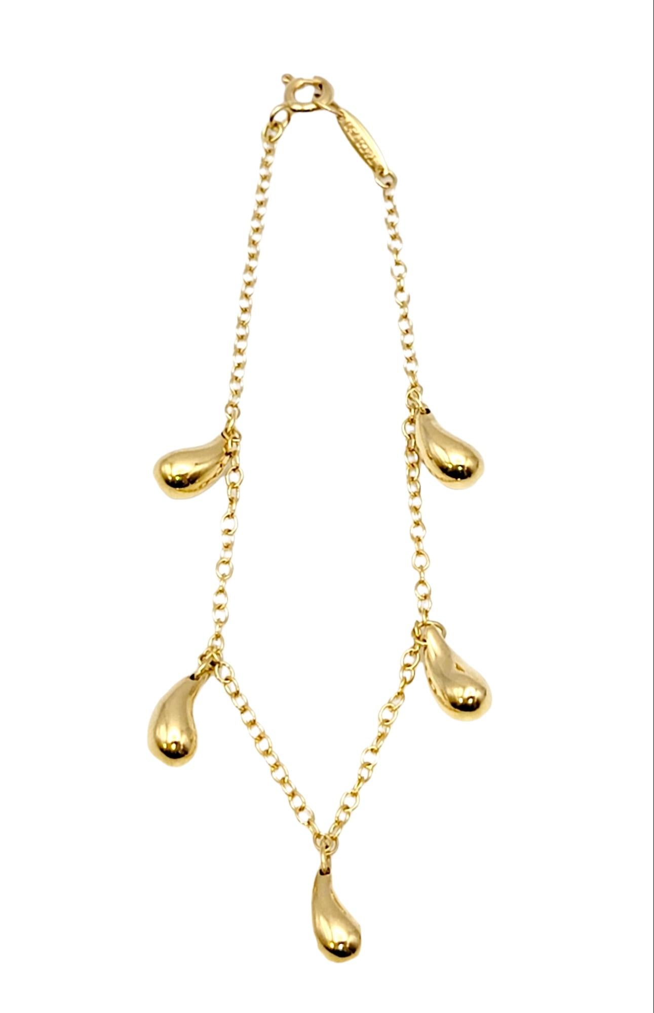 Delicate contemporary station bracelet designed by Elsa Peretti for Tiffany & Co.. Featuring 5 teardrop charms/stations in a high polished 18 karat yellow gold finish. Simple yet elegant, this piece can be worn with just about everything.

Metal: