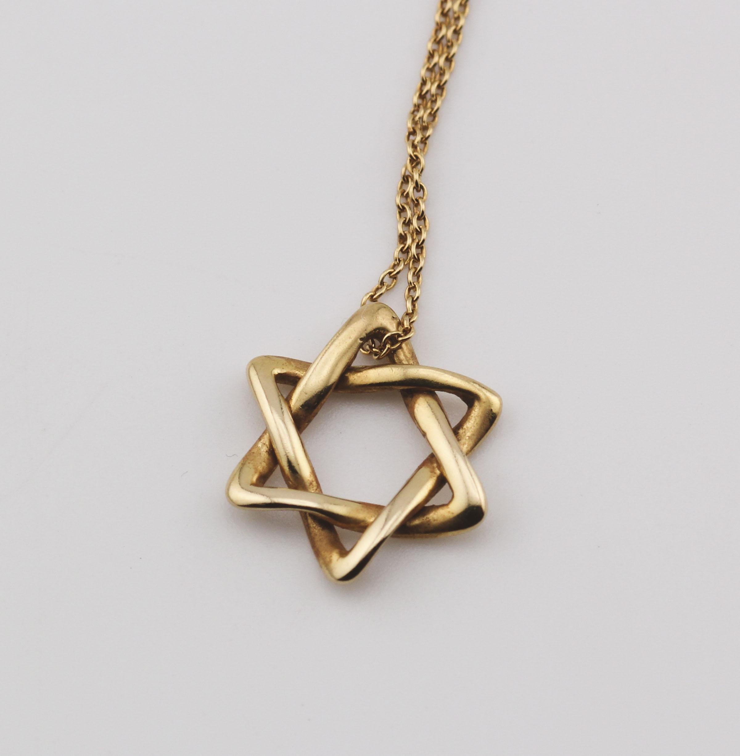 The Tiffany & Co. Elsa Peretti Star of David 18K Yellow Gold Necklace Pendant is a dazzling and meaningful piece of jewelry that beautifully combines iconic design with exquisite craftsmanship. This pendant is part of the celebrated Elsa Peretti