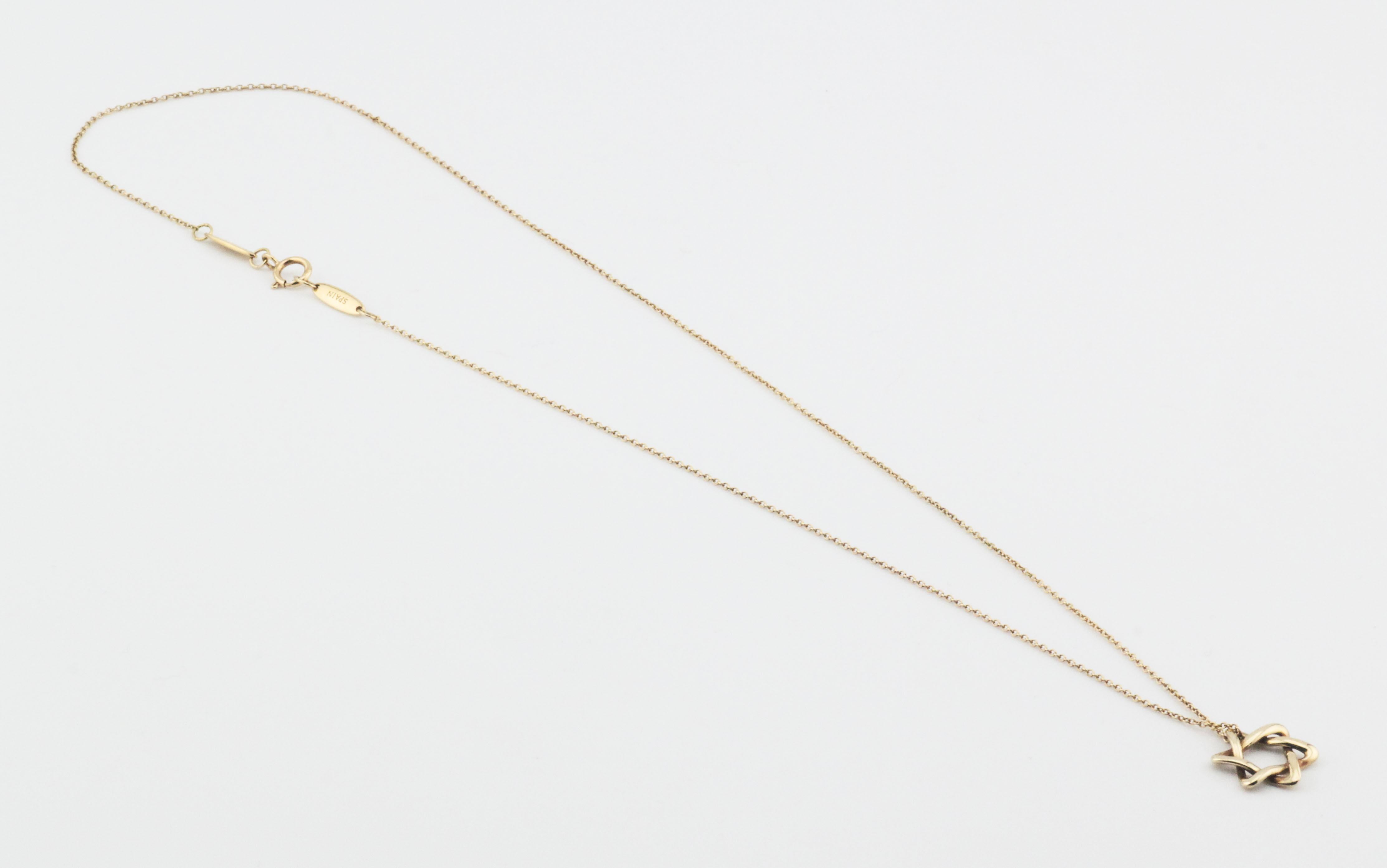 The Tiffany & Co. Elsa Peretti Star of David 18K Yellow Gold Necklace Pendant is a dazzling and meaningful piece of jewelry that beautifully combines iconic design with exquisite craftsmanship. This pendant is part of the celebrated Elsa Peretti