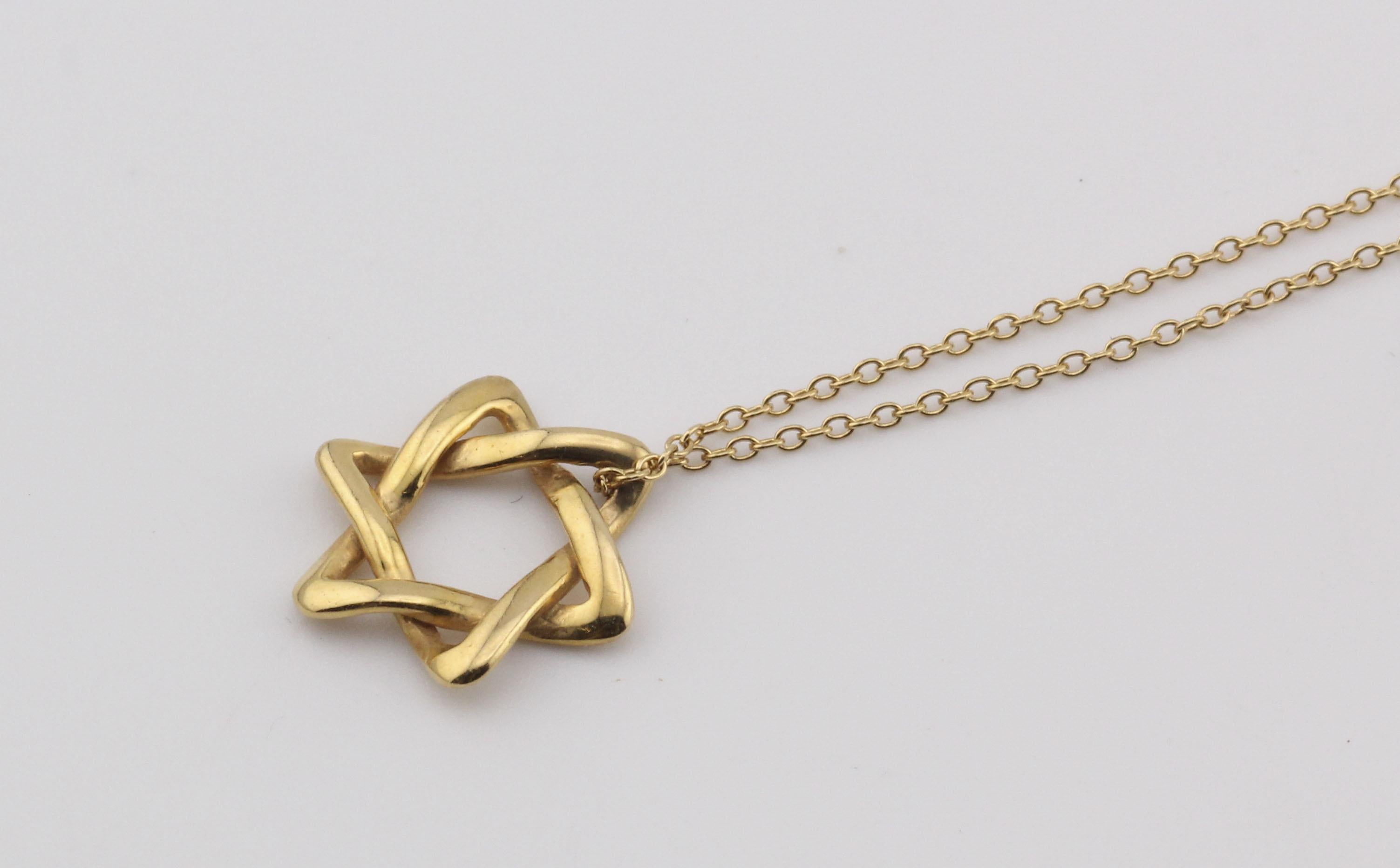 The Tiffany & Co. Elsa Peretti Star of David 18K Yellow Gold Necklace Pendant is a dazzling and meaningful piece of jewelry that beautifully combines iconic design with exquisite craftsmanship. This pendant is part of the celebrated Elsa Peretti