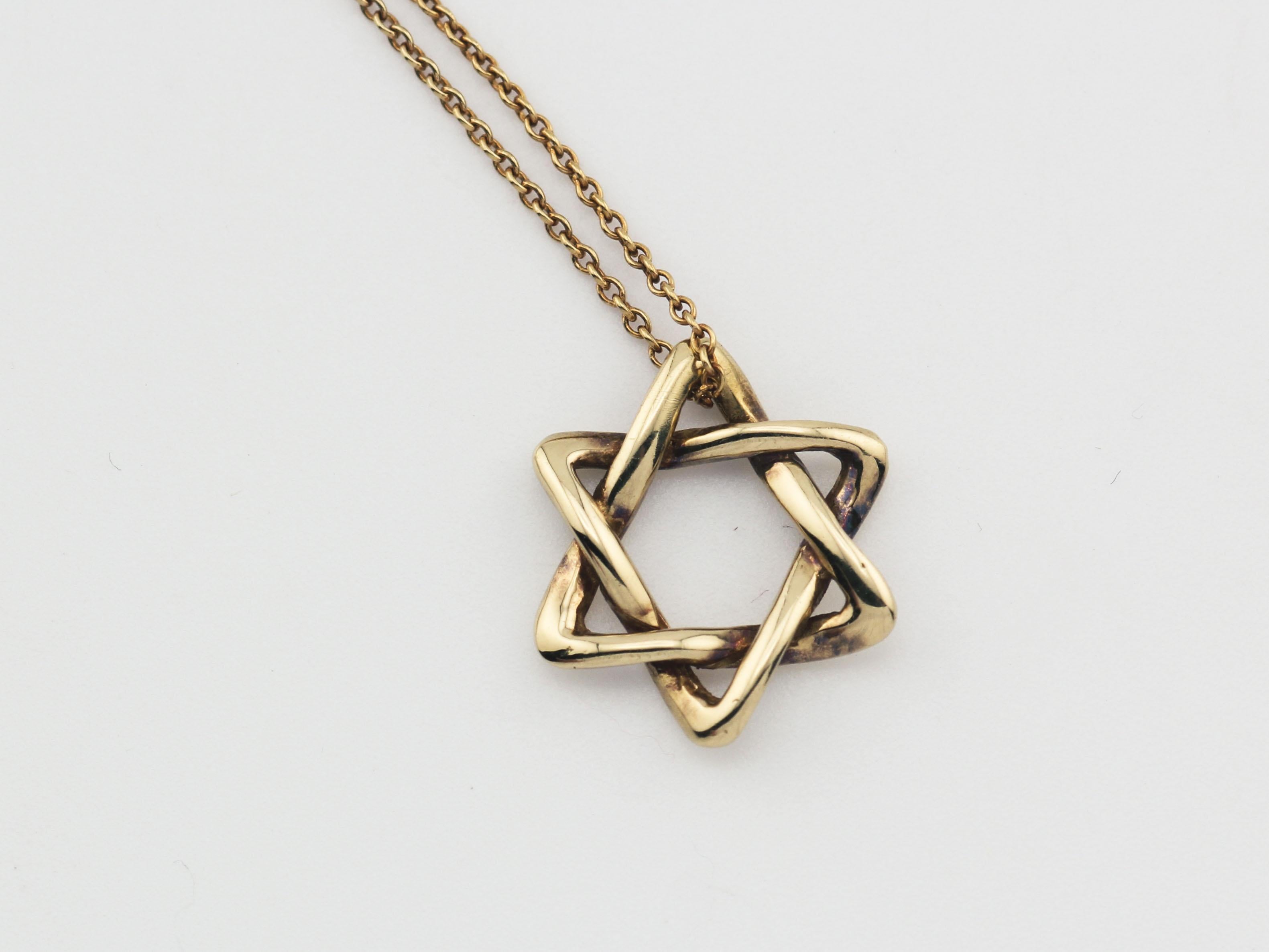 The Tiffany & Co. Elsa Peretti Star of David 18K Yellow Gold Necklace Pendant is a dazzling and meaningful piece of jewelry that beautifully combines iconic design with exquisite craftsmanship. This pendant is part of the celebrated Elsa Peretti