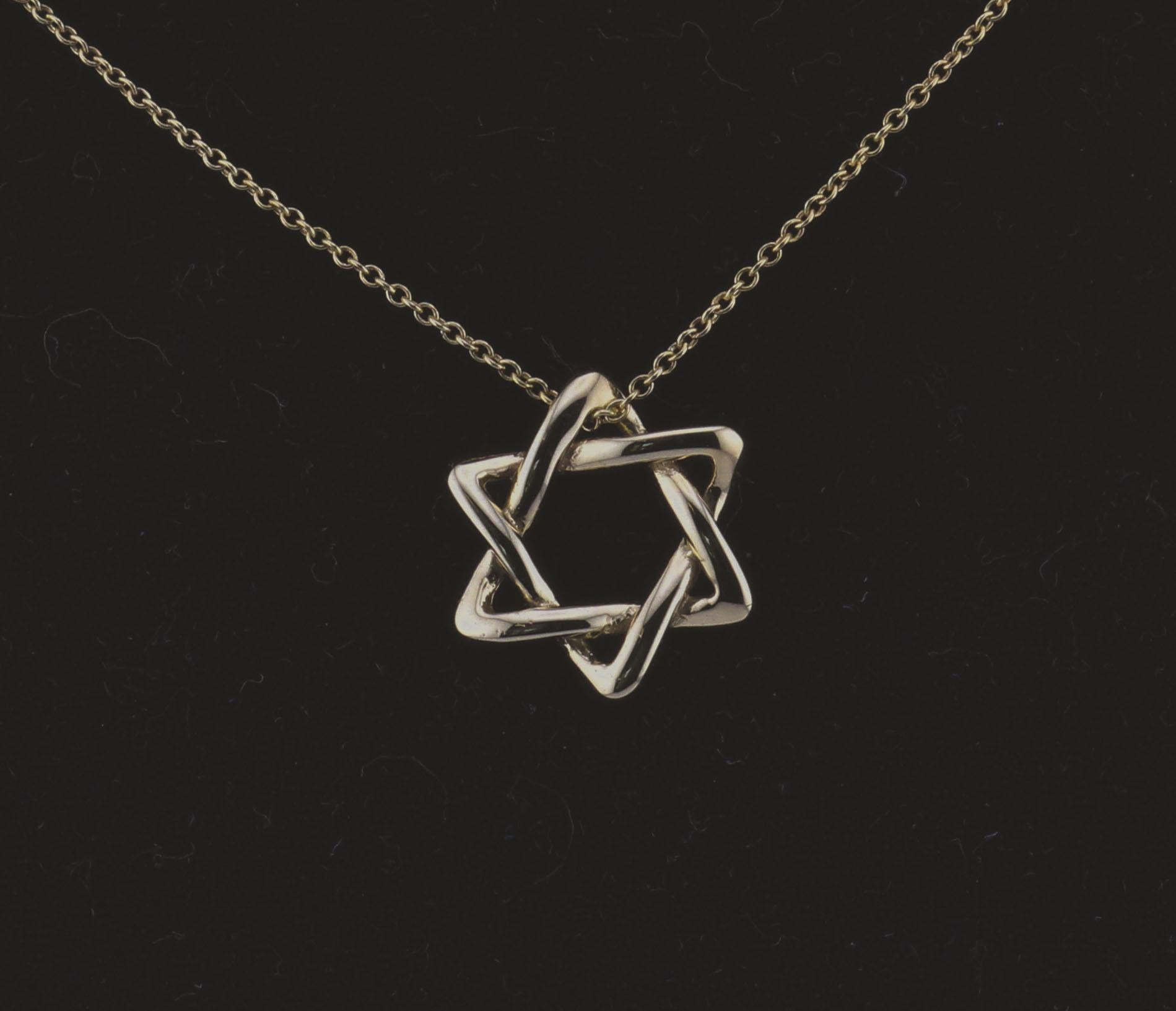 The Tiffany & Co. Elsa Peretti Star of David 18K Yellow Gold Necklace Pendant is a dazzling and meaningful piece of jewelry that beautifully combines iconic design with exquisite craftsmanship. This pendant is part of the celebrated Elsa Peretti