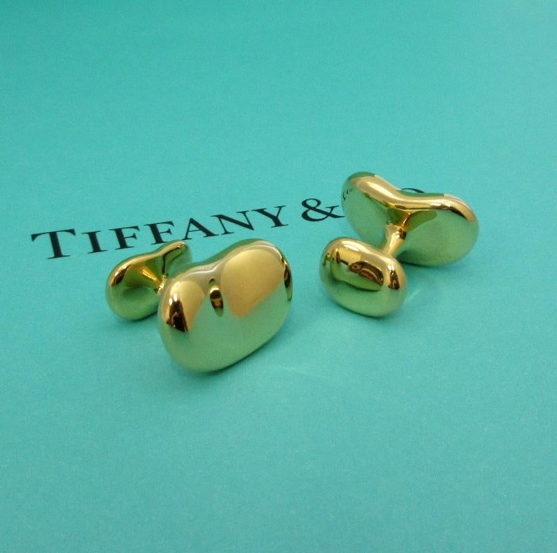 TIFFANY & Co. Elsa Peretti 18K Gold 21mm Wide Bean Cuff Links Cufflinks

Metal: 18K Gold 
Weight: 21.70 grams
Width: 21mm wide, larger size
Hallmark: TIFFANY&CO. © Elsa Peretti 750
Condition: Excellent condition, like new, come with Tiffany pouch