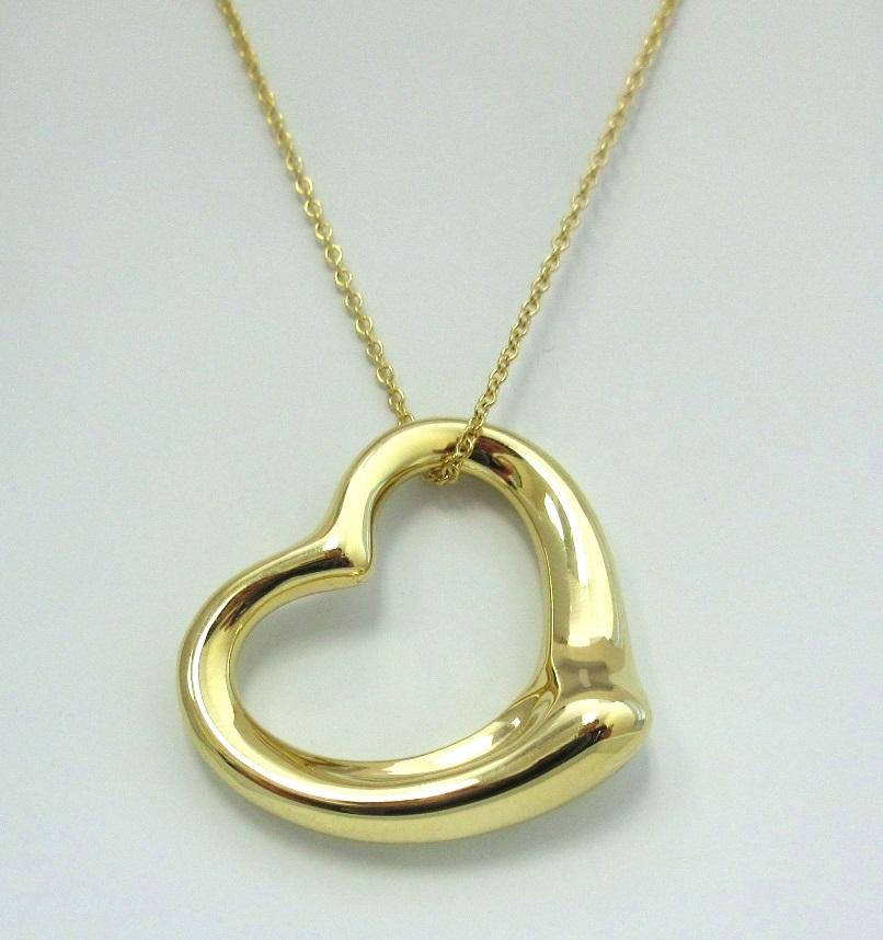 TIFFANY & Co. Elsa Peretti 18K Gold 27mm Open Heart Pendant Necklace

Metal: 18K Yellow Gold
Weight: 9.70 grams
Pendant: 27mm wide 
Chain: 18