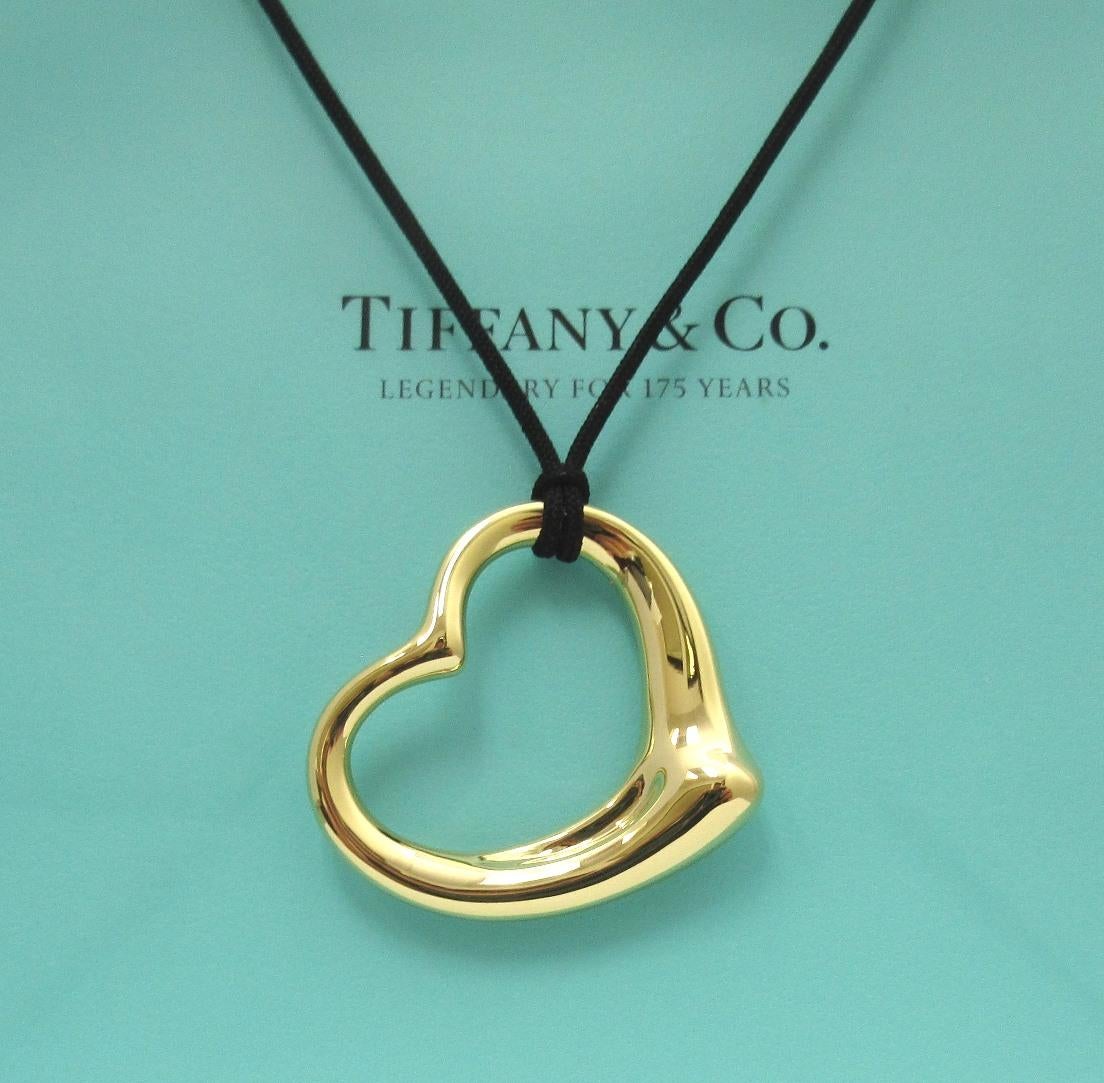 TIFFANY & Co. Elsa Peretti 18K Gold 36mm Open Heart Pendant Necklace

Metal: 18K Yellow Gold
Gold Weight: 11.0 grams
Pendant: 36mm wide 
Silk cord: 16