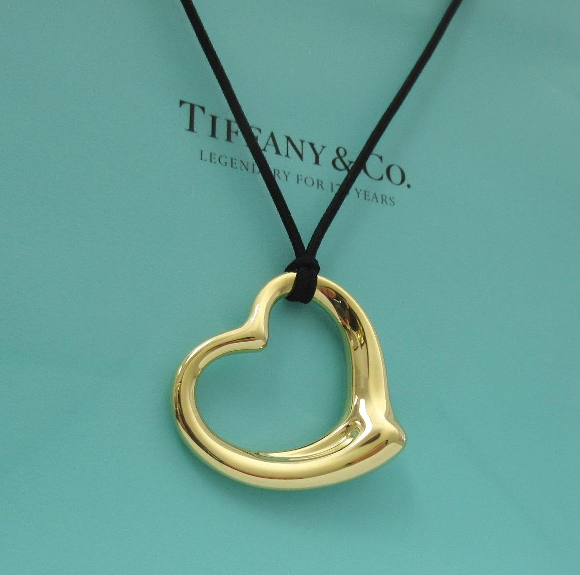 TIFFANY & Co. Elsa Peretti 18K Gold 36mm Open Heart Pendant Necklace

Metal: 18K Yellow Gold
Gold Weight: 11.60 grams
Pendant: 36mm wide 
Silk cord: 16