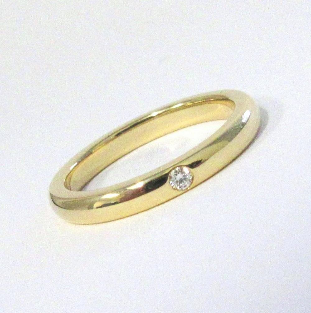TIFFANY & Co. Elsa Peretti 18 Karat Gold Diamantring mit Diamanten 5

Metall: 18K Gelbgold 
Größe: 5
Gewicht: 3.50 Gramm
Breite des Bandes: 2,7 mm
Diamant: Ein runder Brillant, Gesamtgewicht 0,02 Karat 
Markenzeichen: TIFFANY&Co. PERETTI 750