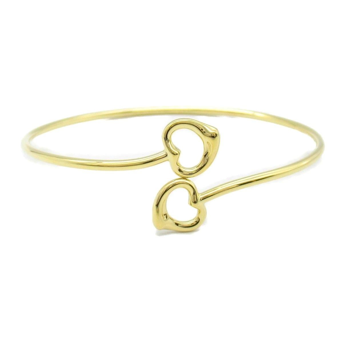TIFFANY & Co. Bracciale con doppio cuore aperto in oro 18 carati di Elsa Peretti

Metallo: oro 18 carati 
Peso: 11.0 grammi 
Dimensioni: Medio
Punzone: 