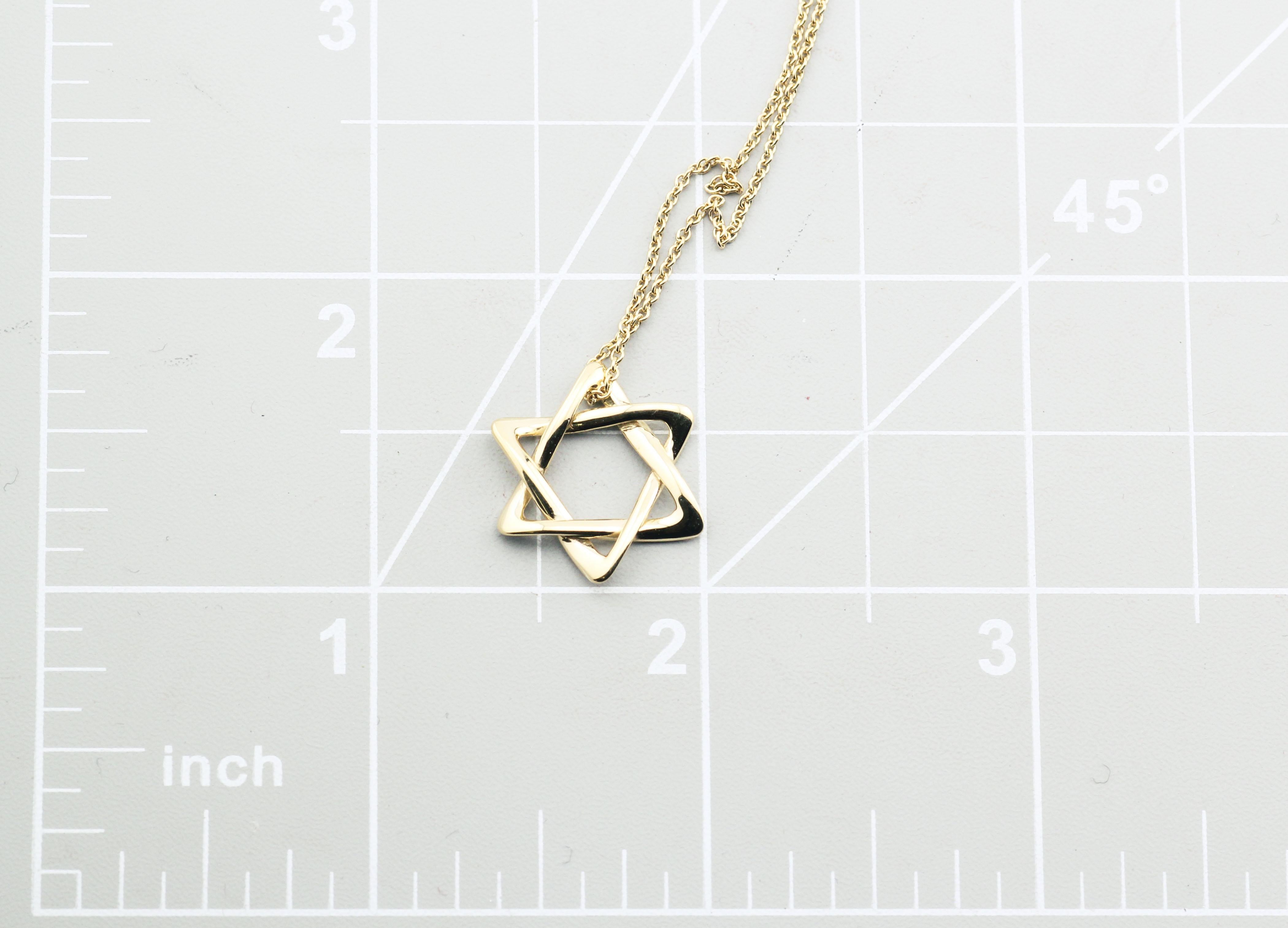Introducing the Tiffany & Co. Elsa Peretti Star of David Large 18k Yellow Gold Pendant Necklace, a magnificent symbol of faith, artistry, and luxury. This exquisite piece of jewelry is a true masterpiece that captures the essence of timeless design