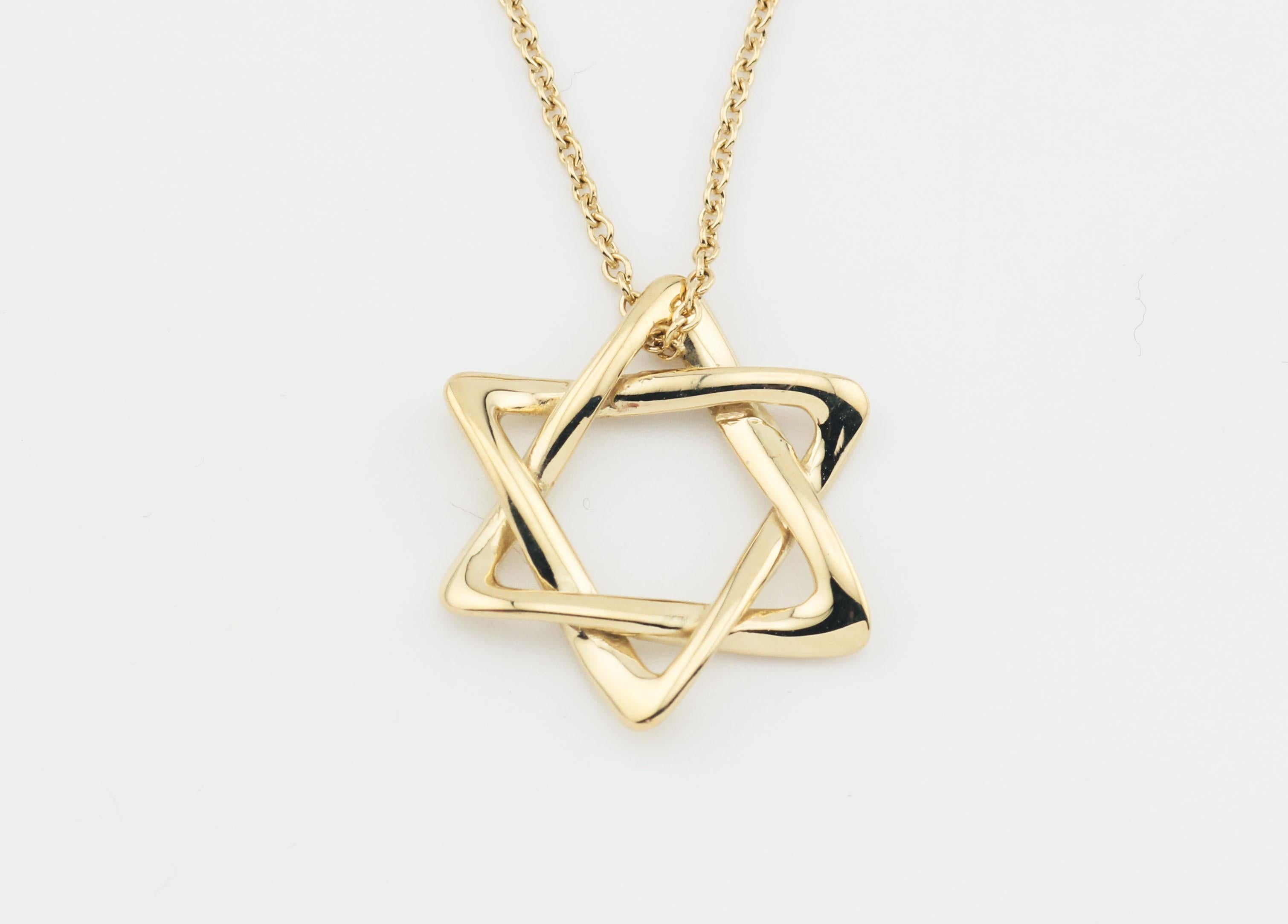 Introducing the Tiffany & Co. Elsa Peretti Star of David Large 18k Yellow Gold Pendant Necklace, a magnificent symbol of faith, artistry, and luxury. This exquisite piece of jewelry is a true masterpiece that captures the essence of timeless design