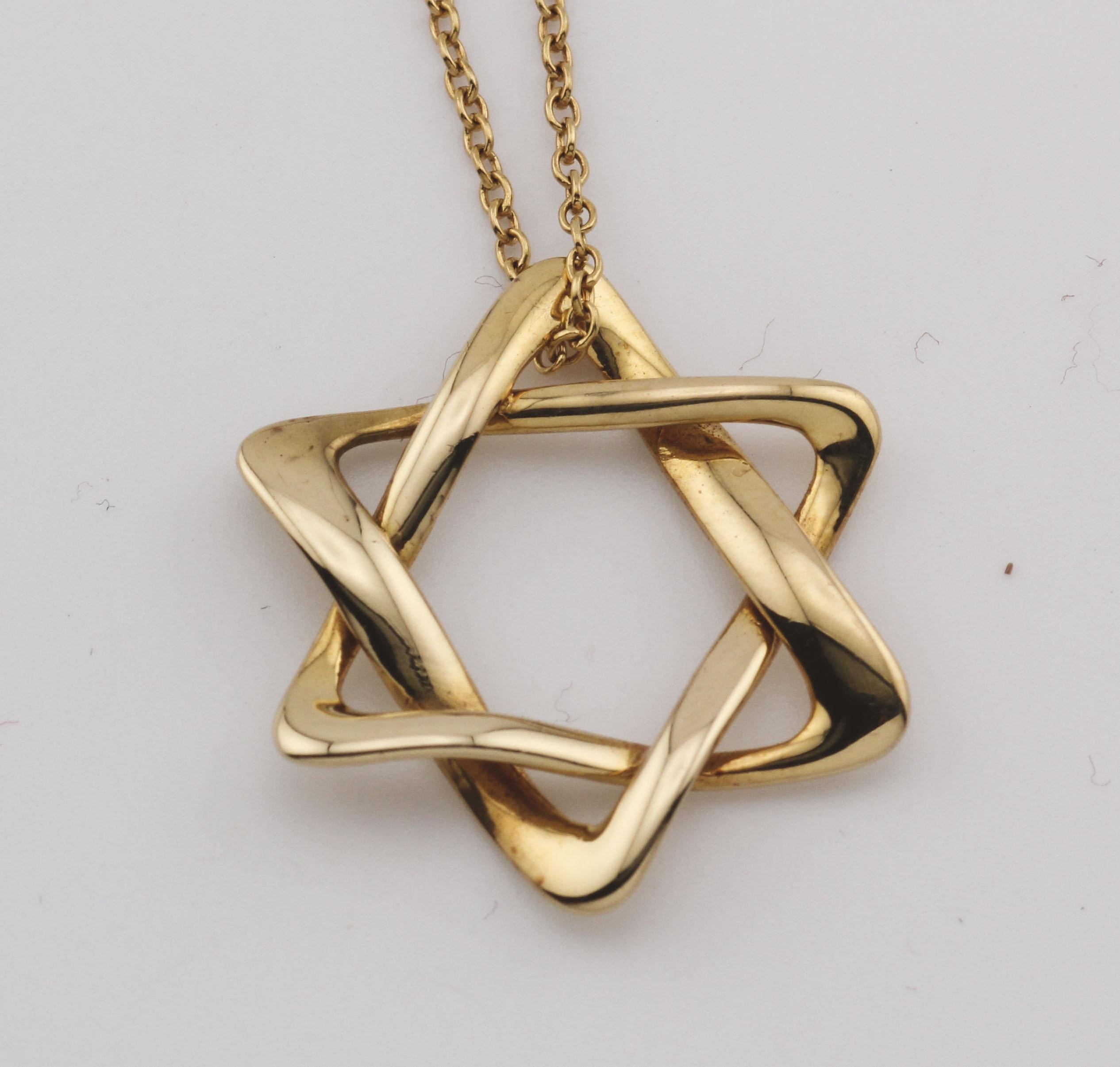 Introducing the Tiffany & Co. Elsa Peretti Star of David Large 18k Yellow Gold Pendant Necklace, a magnificent symbol of faith, artistry, and luxury. This exquisite piece of jewelry is a true masterpiece that captures the essence of timeless design
