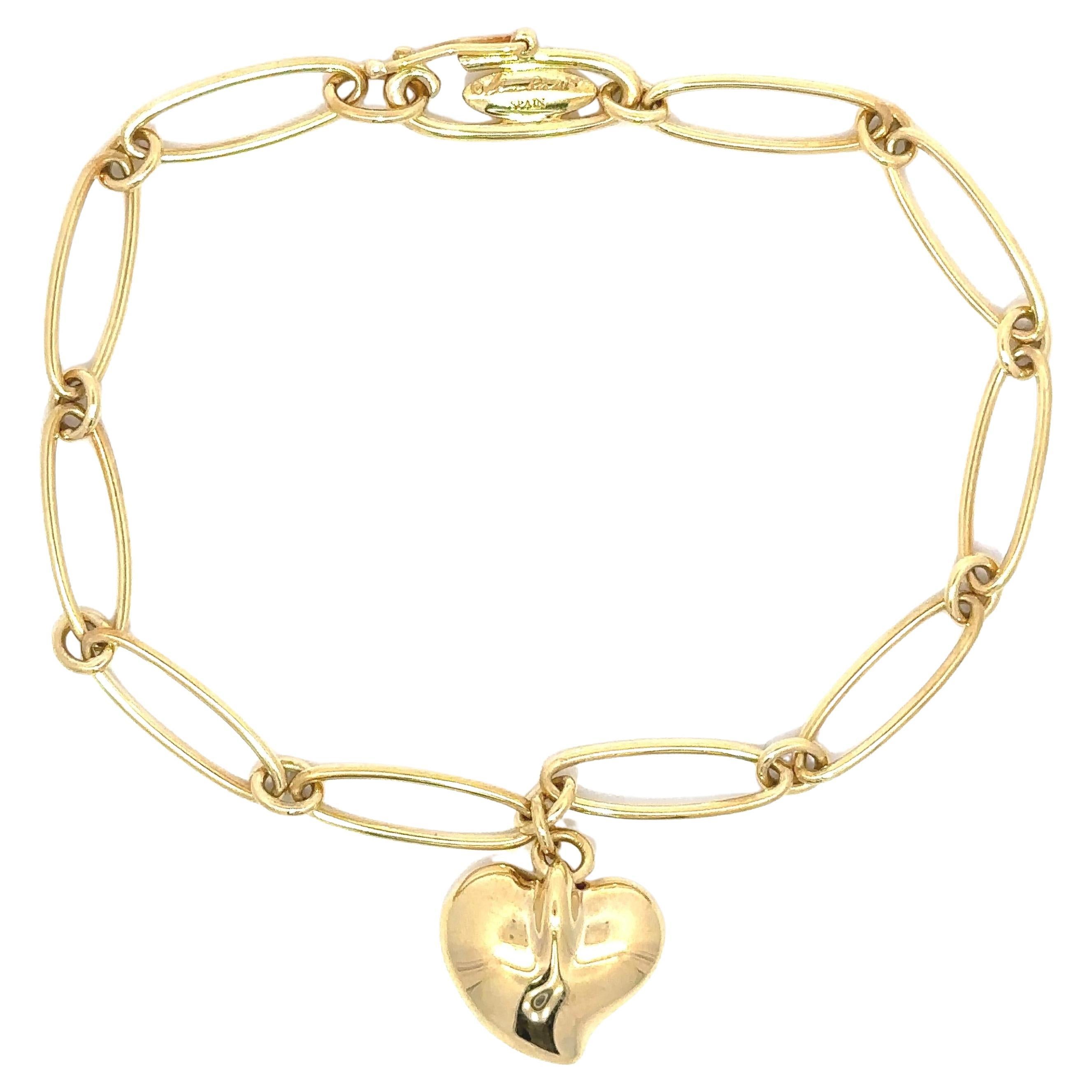 Tiffany
Co. Elsa Peretti Pulsera de eslabones ovalados abiertos de oro de 18k Colgante de corazón