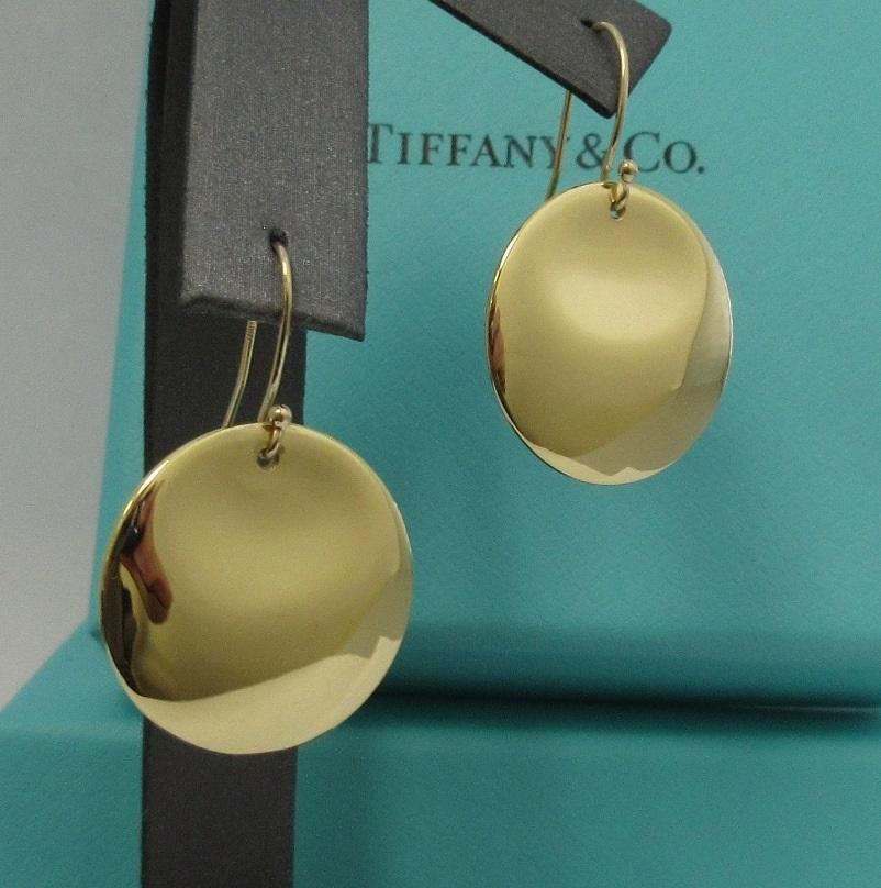 TIFFANY & Co. Elsa Peretti 18K Gold Round Earrings

Metal: 18K yellow gold
Weight: 9.30 grams
Measurements: 24mm diameter
Hallmark: TIFFANY&CO. ©Elsa Peretti 750 SPAIN
Condition: Excellent condition, like new, come with Tiffany pouch, box and ribbon