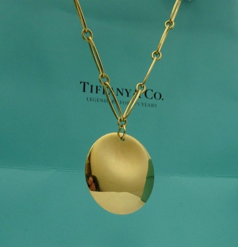 TIFFANY & Co. Elsa Peretti 18K Gold Round Pendant Oval Link Necklace 

Metal: 18K yellow gold
Weight: 22.20 grams
Oval link: 16.5