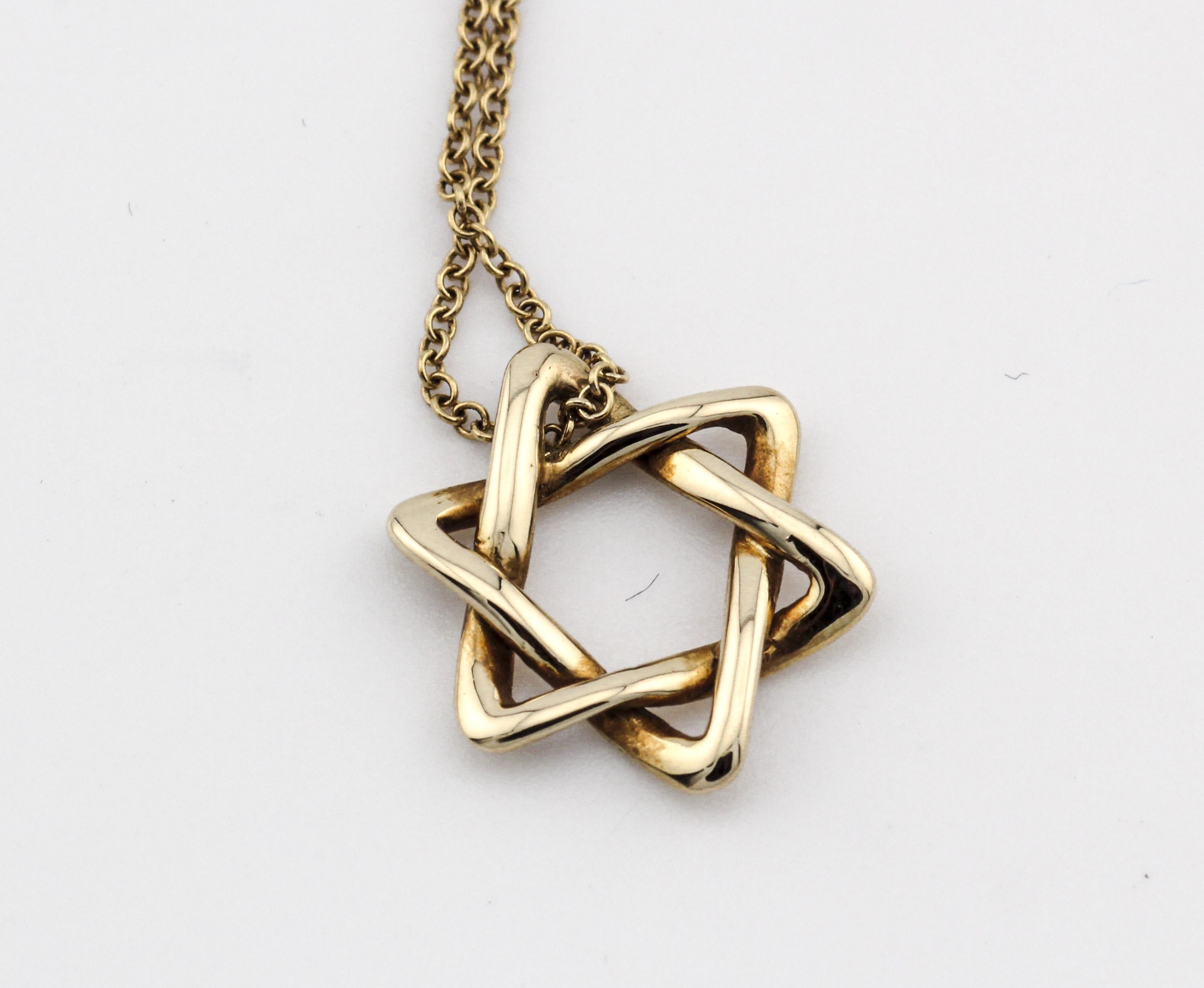 The Tiffany & Co. Elsa Peretti Star of David 18K Yellow Gold Necklace Pendant is a dazzling and meaningful piece of jewelry that beautifully combines iconic design with exquisite craftsmanship. This pendant is part of the celebrated Elsa Peretti