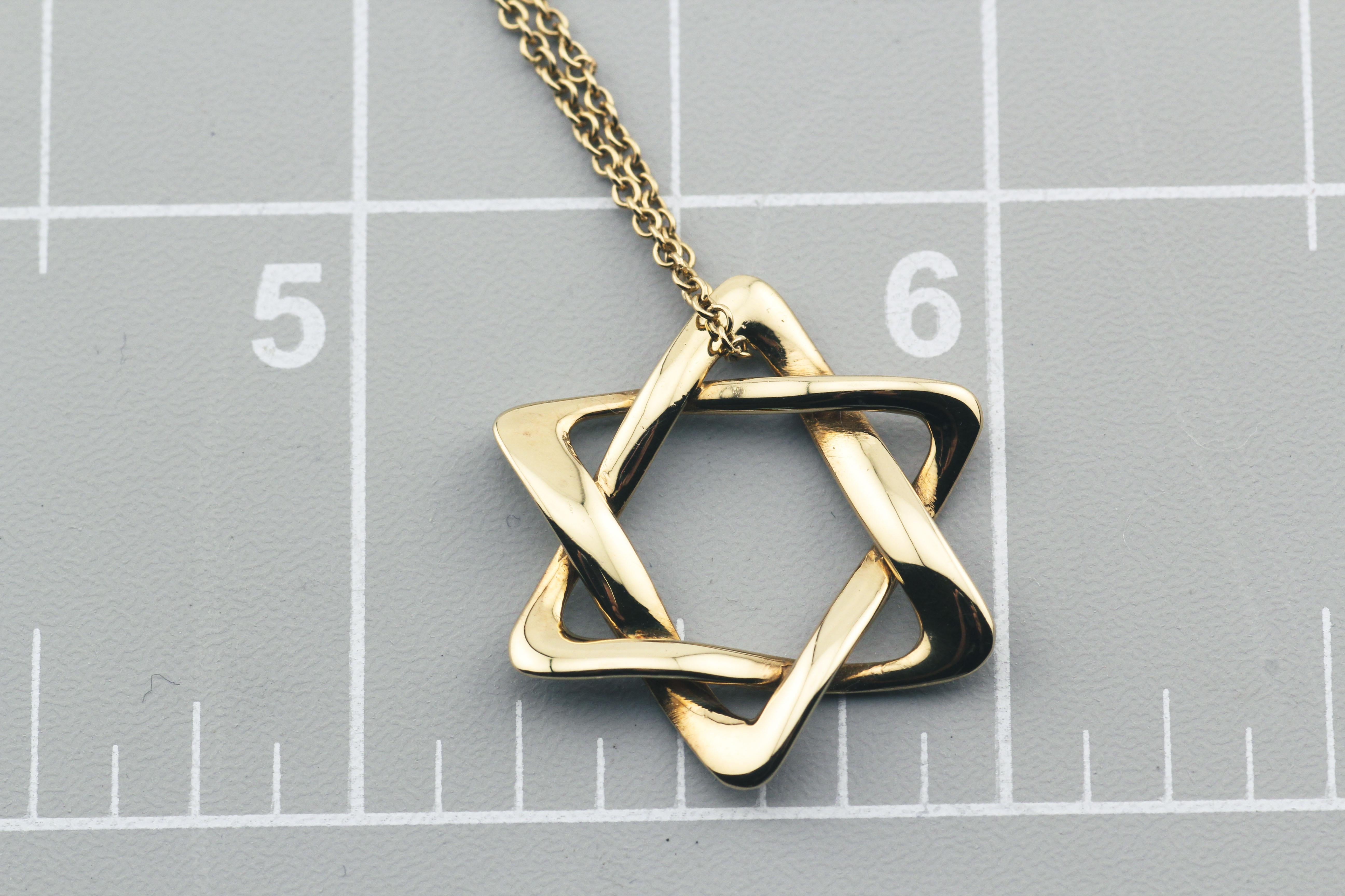 The Tiffany & Co. Elsa Peretti 18K Yellow Gold 22 mm Star of David Pendant Necklace is a stunning embodiment of both faith and fashion. Crafted by the esteemed designer Elsa Peretti, this necklace combines elegance with spiritual significance in a