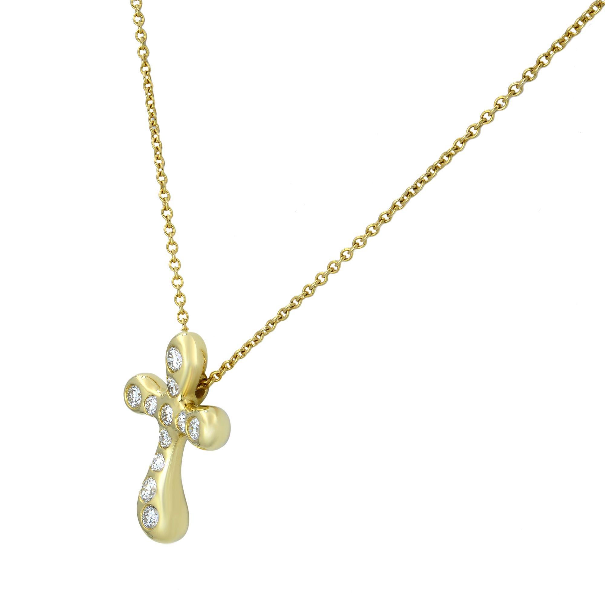 Tiffany & Co Elsa Peretti cross pendant in 18k yellow gold. Bezel set with 0.25 carat of round brilliant cut diamonds. Original designs copyrighted by Elsa Peretti. Cross size: 18.50mm x 13.50mm. Chain length: 16 inches. great pre-owned condition.