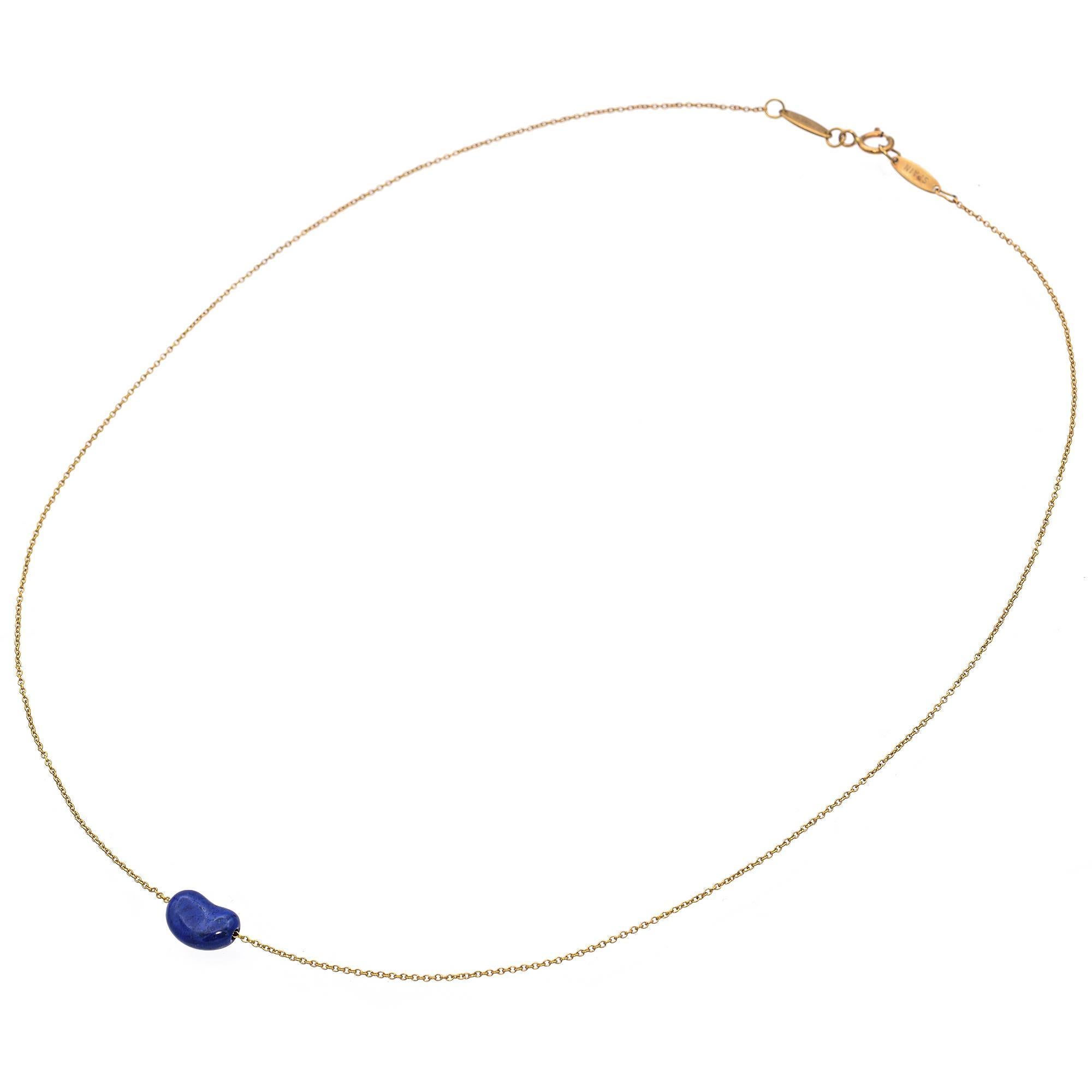 Experience the refined simplicity of this Lapis Lazuli Pendant Necklace, crafted by Tiffany & Co. in the 20th century.
The necklace is made with 18k yellow gold, featuring a signature, smooth lapis lazuli bean.
The design highlights the natural