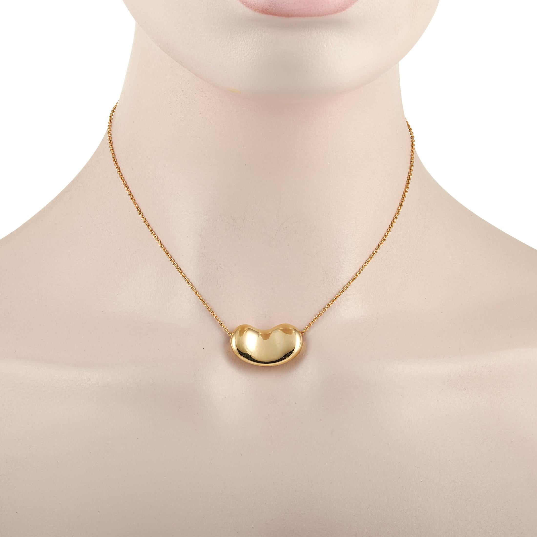 This classic Tiffany & Co. Elsa Peretti 18K Yellow Gold Large Bean Necklace is crafted from 18K yellow gold and features a bean pendant designed by Elsa Peretti. The dainty chain measures 14 inches in length and features a spring ring closure. The