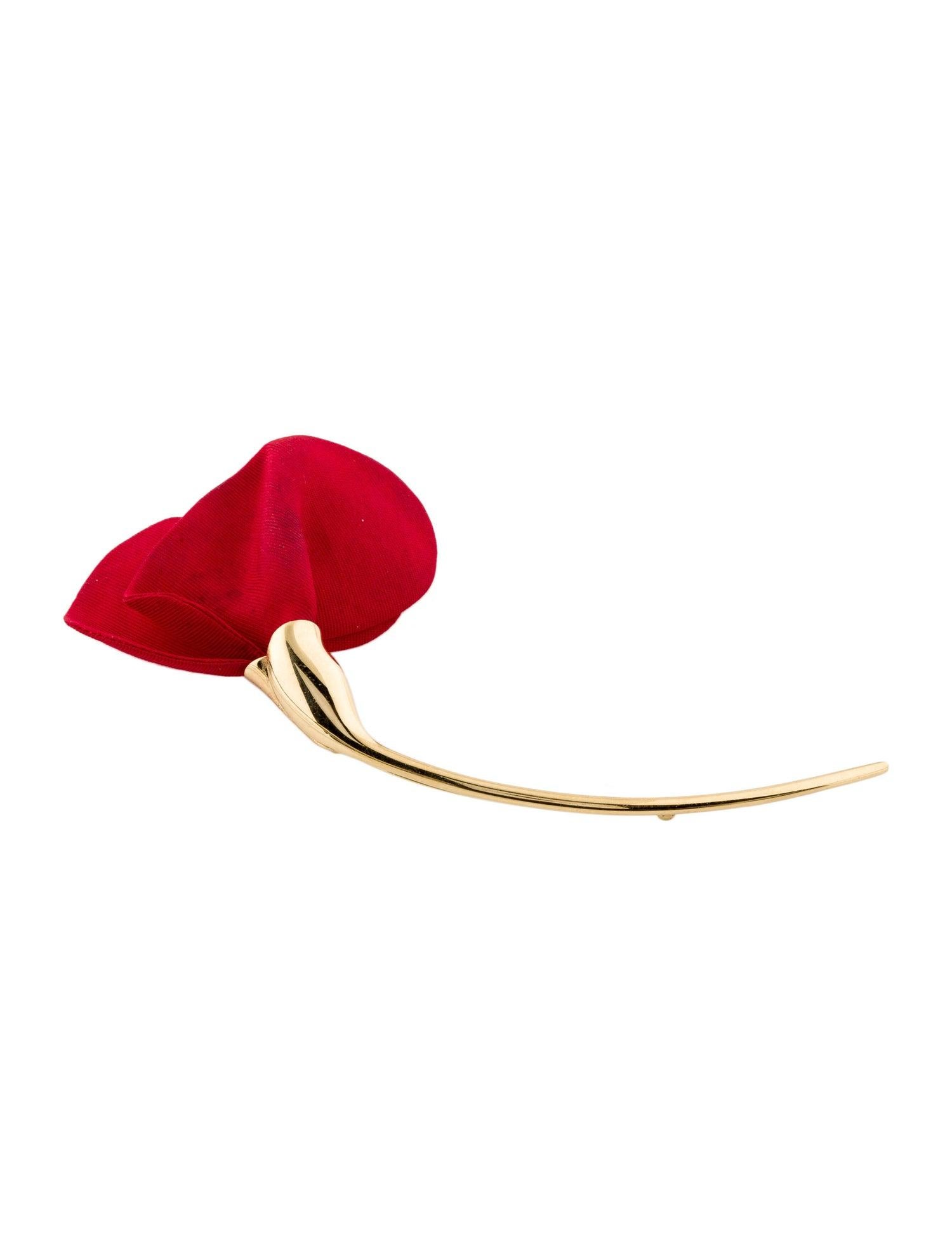 Designed as a flowing silk flower with gold stem

Created by Elsa Peretti for the Tiffany Amapola collection

Highly polished 18 karat gold

Fully signed Tiffany & Co., 750 Spain

Measures 4.75 x 2.25 inches

Total weight: 13.7 grams

Symbolic.