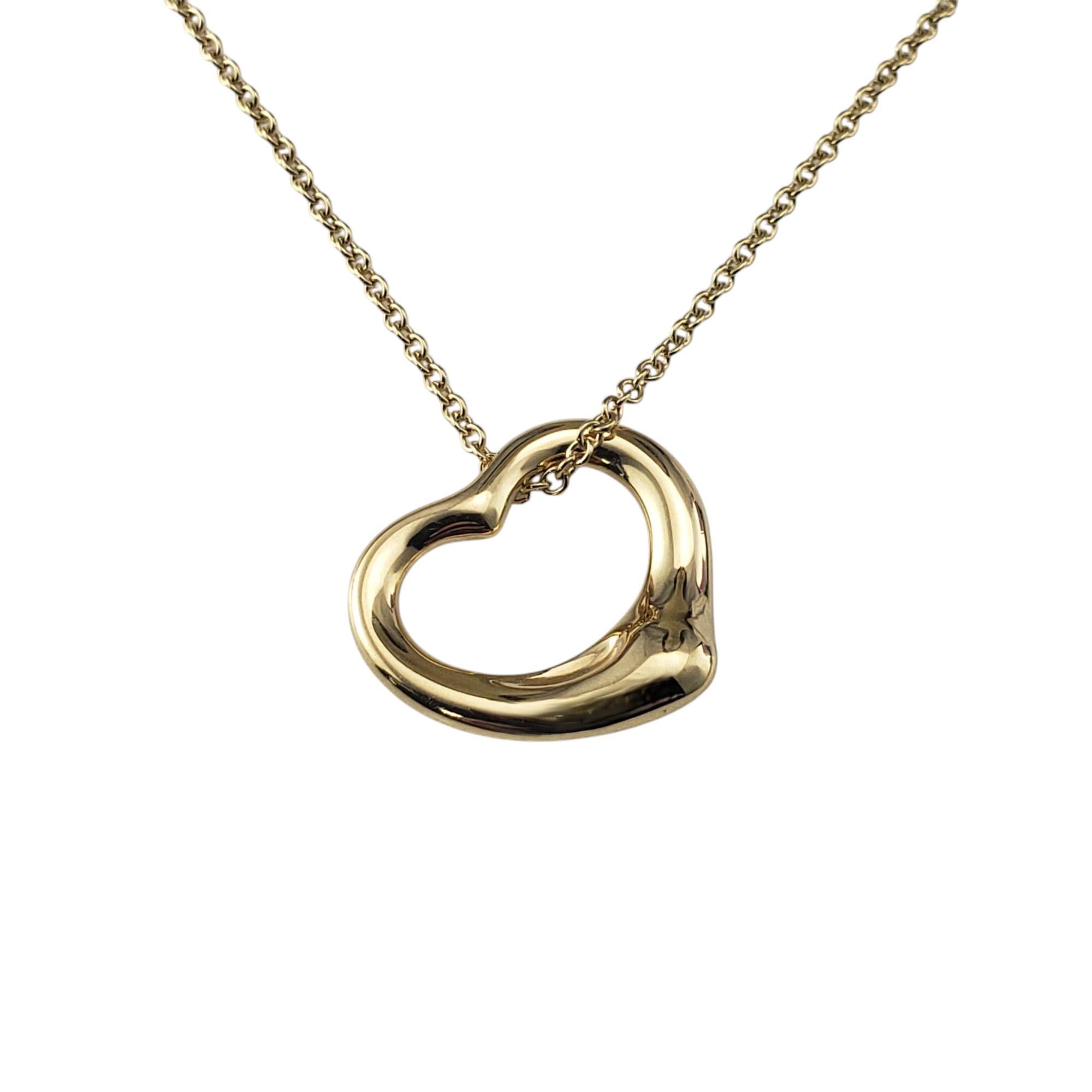 Tiffany & Co. Elsa Peretti 18K Yellow Gold Open Heart Pendant Necklace-

This iconic piece from Tiffany & Co. is renowned for its elegant simplicity and fluid design. Crafted from 18K yellow gold, the pendant features Peretti's signature open heart