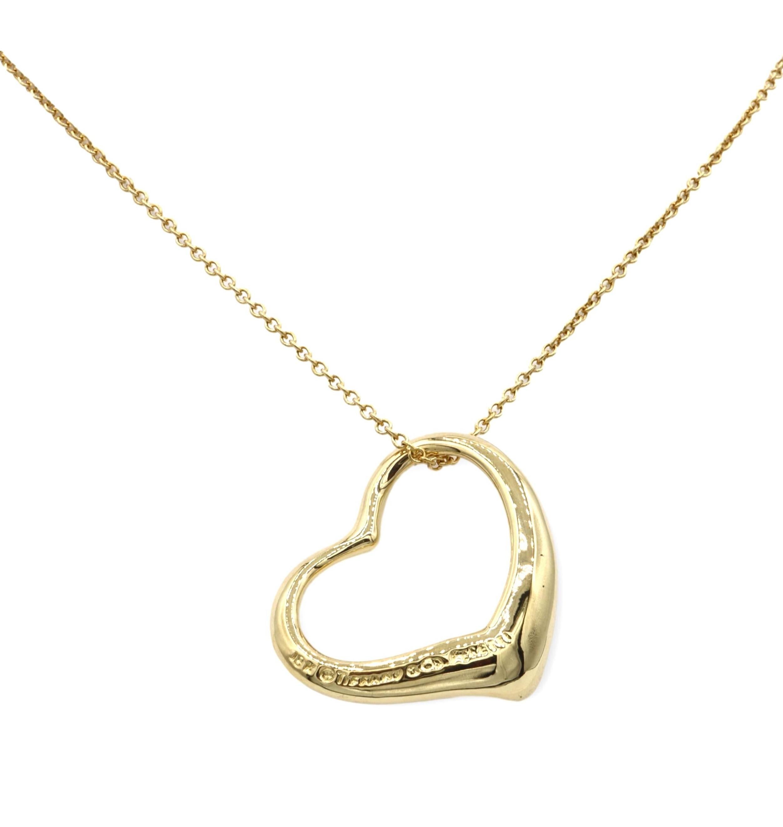 Elsa Peretti for Tiffany & Co. open heart pendant necklace finely crafted in 18 karat yellow gold with a 16” long cable link chain with spring ring closure. The heart pendant measures 22 mm. Fully hallmarked with logo and metal content.

NECKLACE 