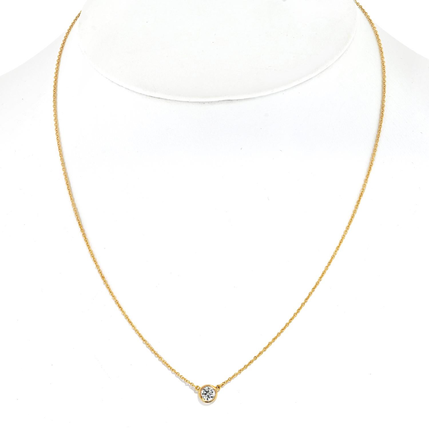 Elevate your elegance with the timeless beauty of our Estate Tiffany & Co. 18K Yellow Gold 0.45ct Round Diamond Bezel Set Pendant Necklace. This exquisite piece is a testament to Tiffany's legacy of craftsmanship and sophistication.

Crafted from