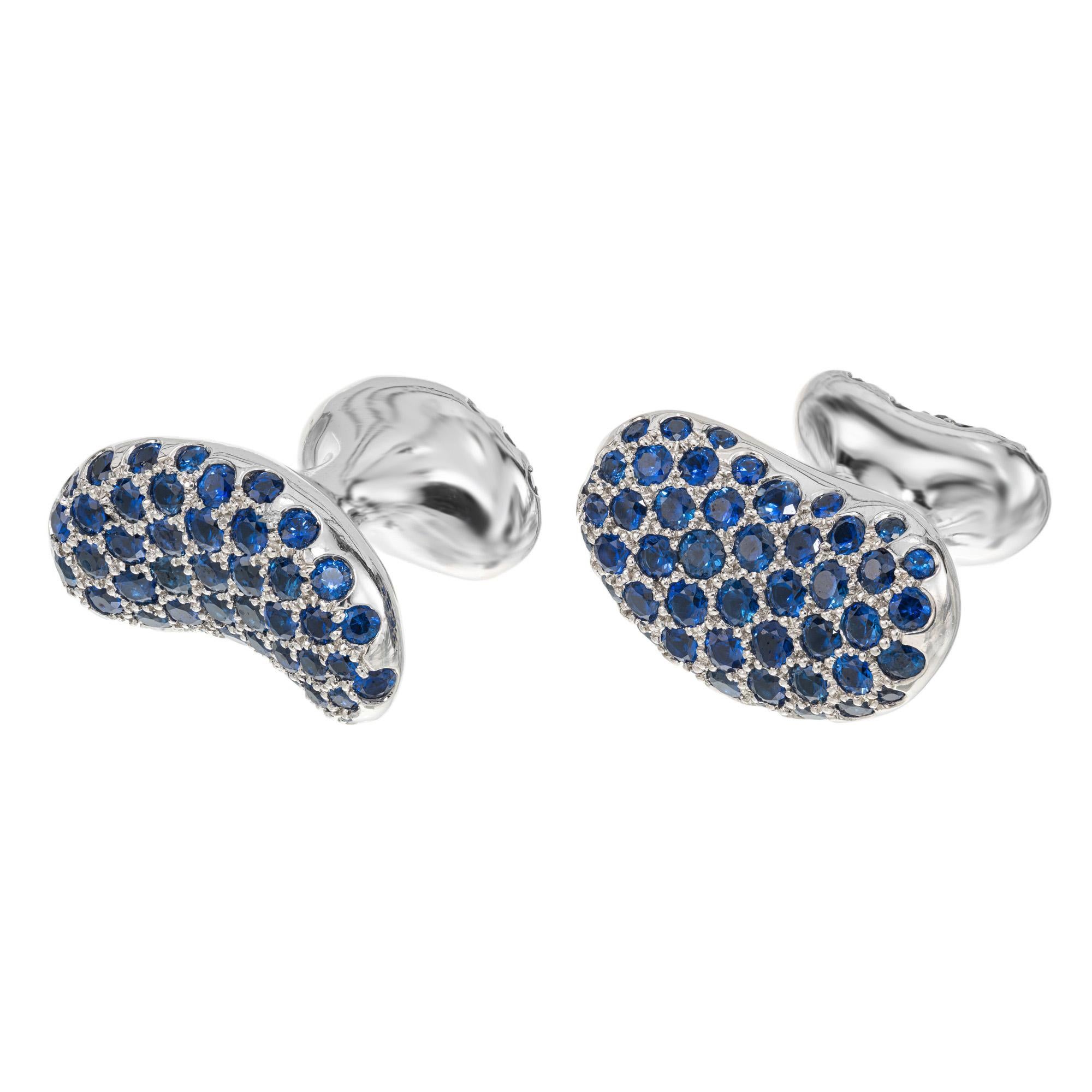 Extraordinary Tiffany & Co Elsa Peretti sapphire bean men's cufflinks. Crafted out of solid platinum, these classic Peretti bean style cufflinks are adorned with a total of 166 round blue sapphires on both sides brining the total carat weight to