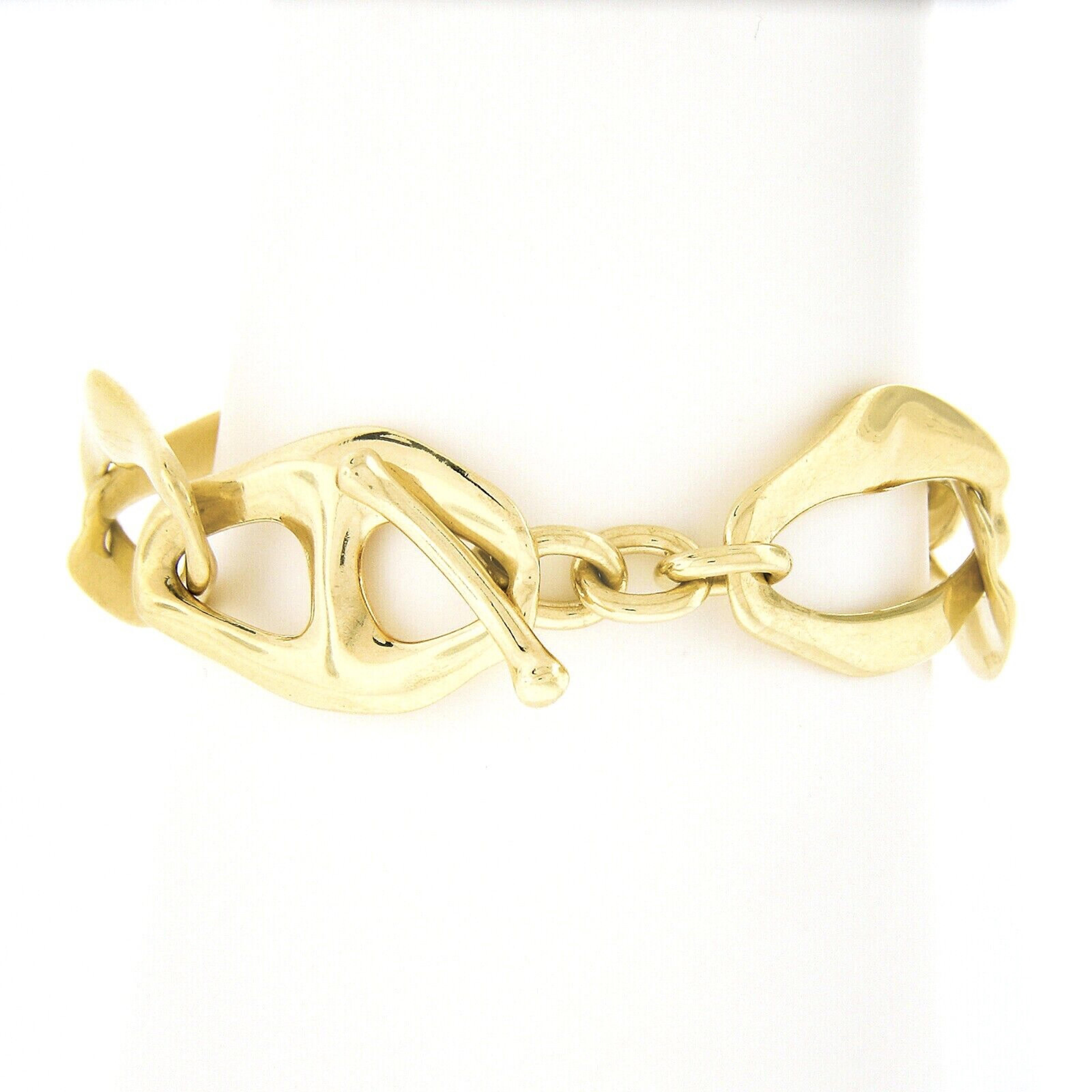 You are looking at an absolutely gorgeous Tiffany & Co. Aegean bracelet crafted in solid 18k yellow gold designed by Elsa Peretti. This beautiful bracelet features large wavy open links that have wonderful high polished finish throughout giving this