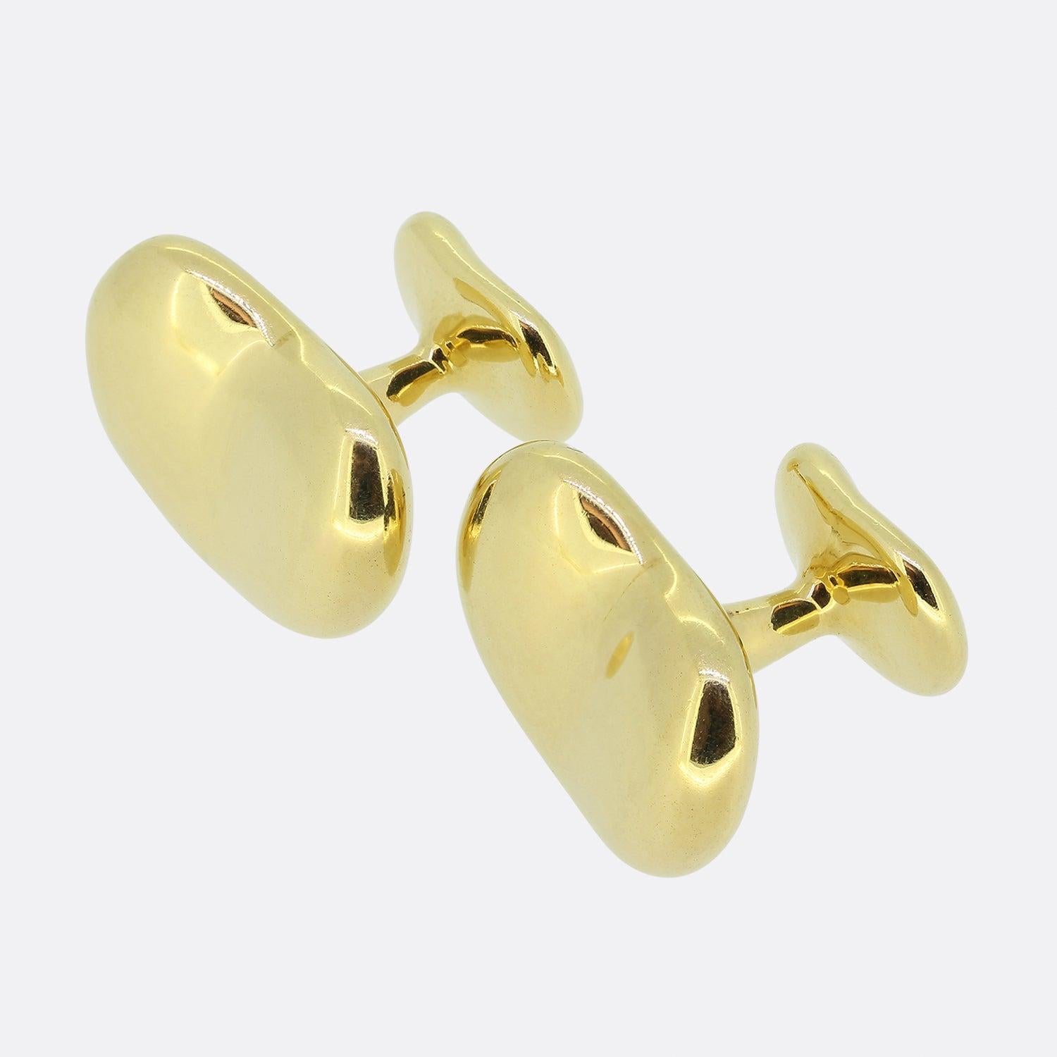 This is a vintage pair of 18ct yellow gold cufflinks from the world renowned jewellery designer, Tiffany & Co. 

Introduced in the early 1970s, Elsa Peretti’s iconic Bean design is a symbol of life’s origins. A beautifully humble form, the bean’s