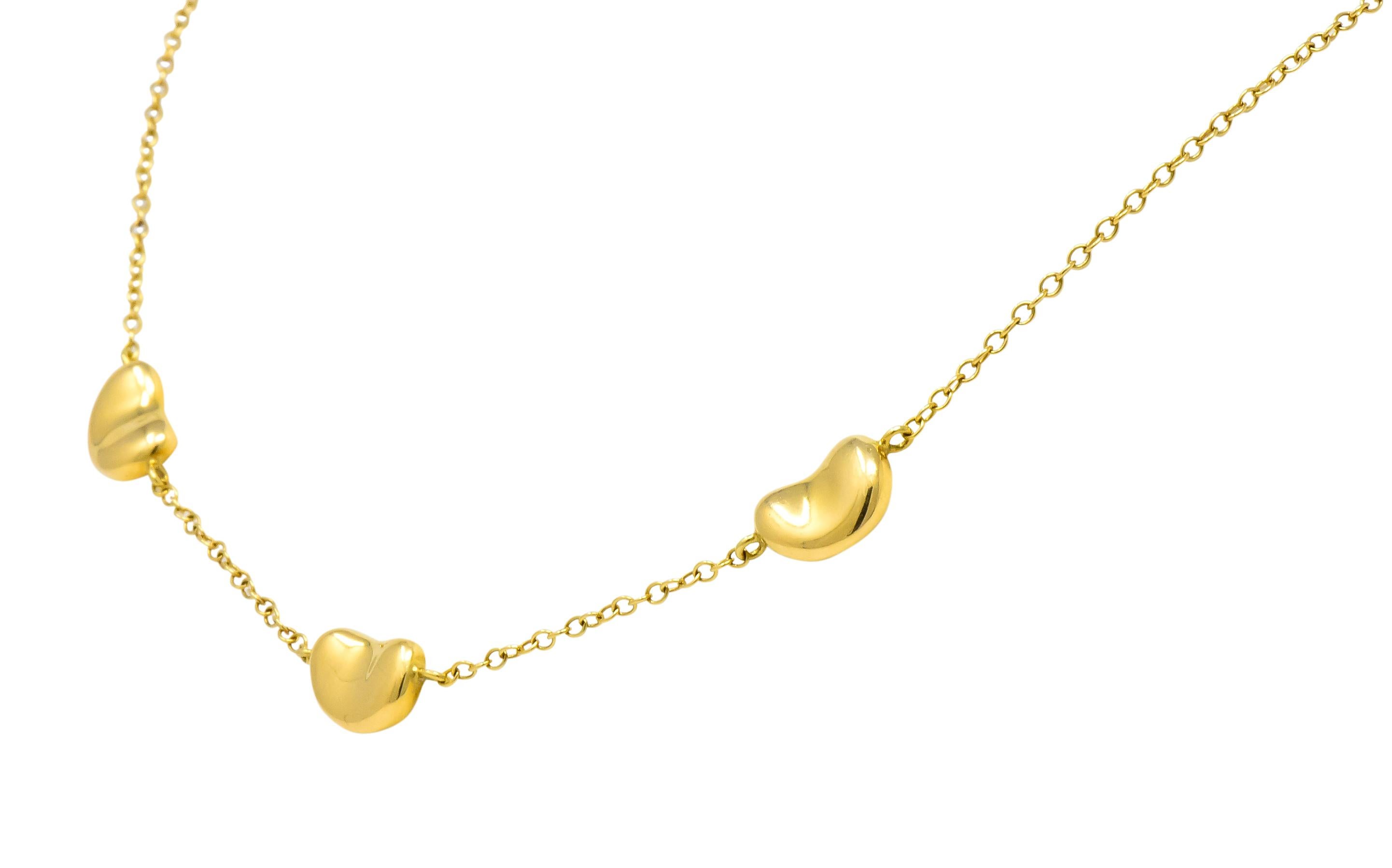 Set to the front with three high polished gold 'beans' measuring approximately 10.5 x 7.5 mm

Connected and completed by cable style chain with spring ring clasp

From her Bean Design collection

Fully signed Tiffany & Co., Elsa Peretti and stamped