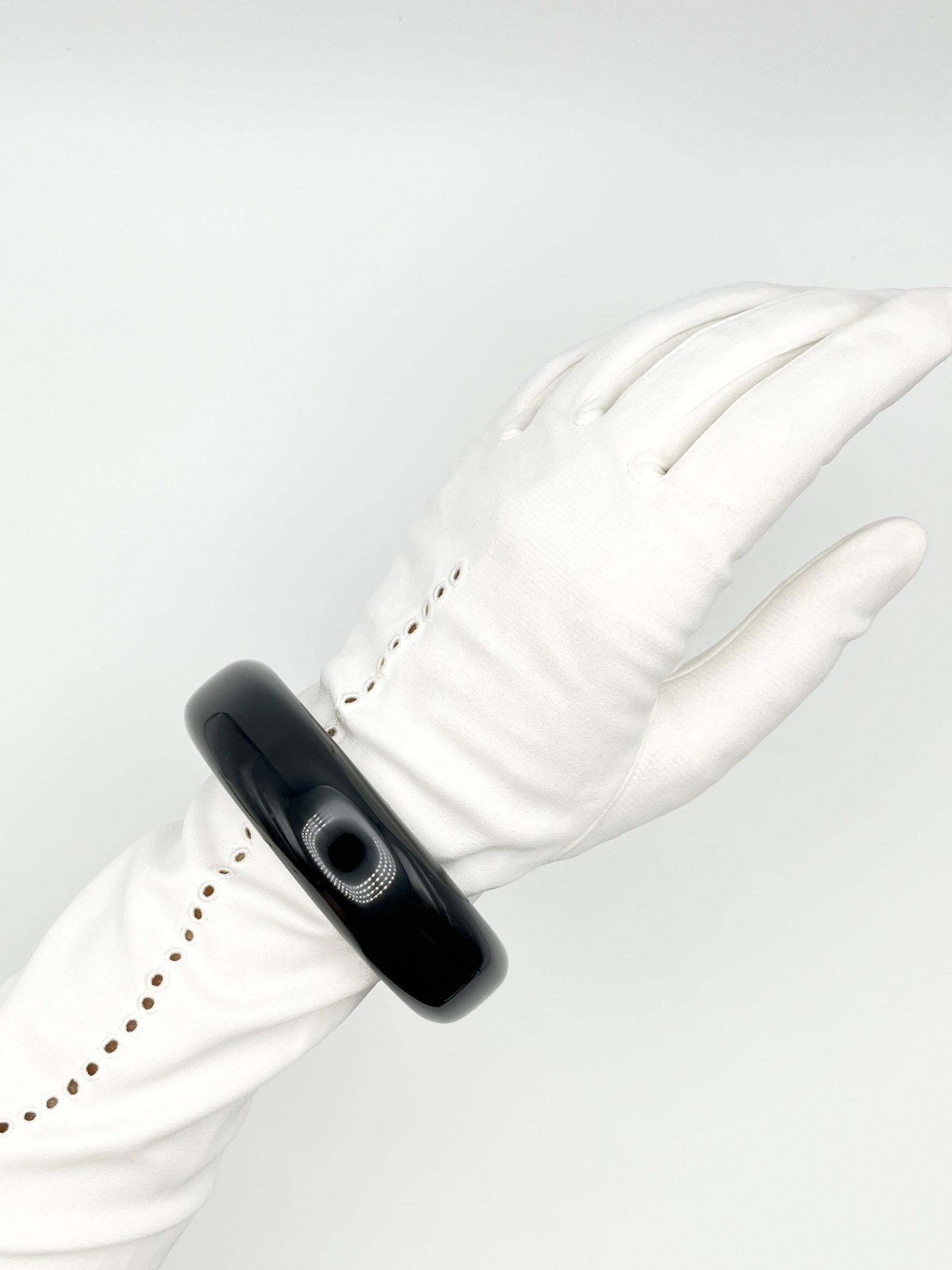 Este icónico brazalete lacado, diseñado por Elsa Peretti para Tiffany & Co., se fabrica en Japón. Este atrevido diseño muestra la estética minimalista característica de Peretti, con suaves curvas esculturales y un acabado en lacado negro