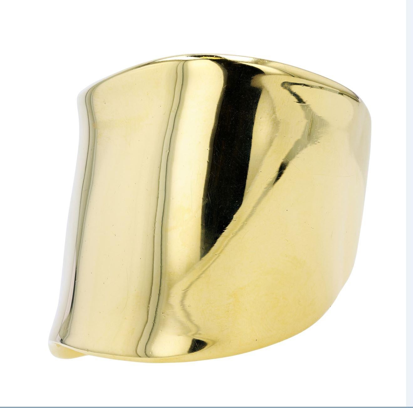 A 1980s Elsa Peretti for Tiffany & Co. Bone Cuff in 18 karat yellow gold.

Designed in the early 1970s at the beginning of Elsa Peretti's career at Tiffany & Co., the Bone Cuff entered the world of high style at an inflection point in the worlds of