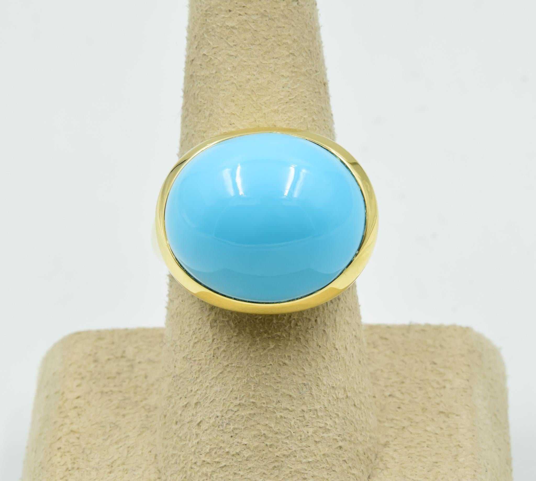 This 18k yellow gold ring set with a 19mm turquoise is an Elsa Peretti design by Tiffany & Co. The ring is a size 8. The ring top is 18mm x 21mm and sits approximately 16mm from the finger. This ring was traded in recently to our store and is in