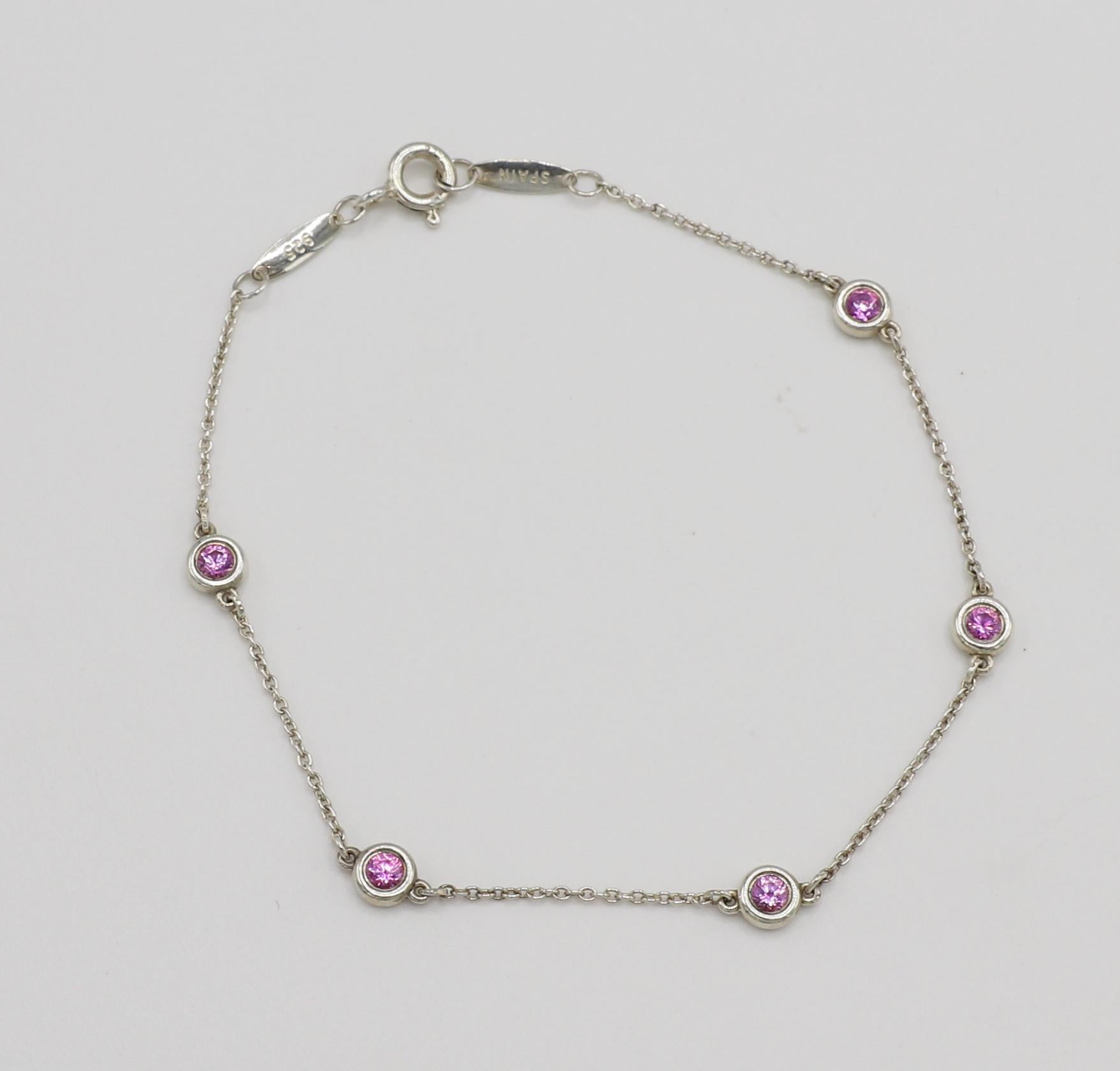Tiffany & Co. Elsa Peretti Color By The Yard Sterling Silver 5 Sapphire Bracelet
Metal: Sterling silver, 925
Weight: 1.78 grams
Length: 7 inches
Sapphires: 5 round pink sapphires, approx. 0.55 CTW 
