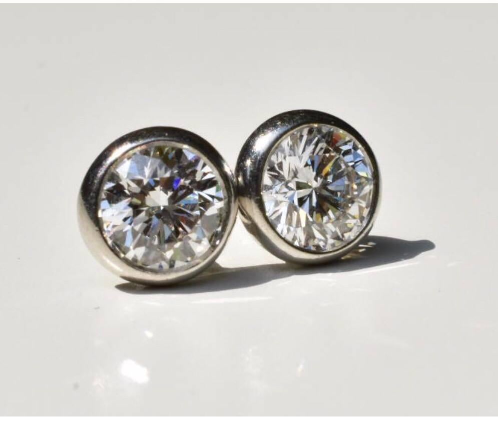 A pair of Tiffany & Co Peretti diamond solitaire earring set in platinum. Each earring features a brilliant-cut round diamond of approx 0.86 carats set to a platinum setting. The earrings are sold with the original box, and Tiffany & Co retail
