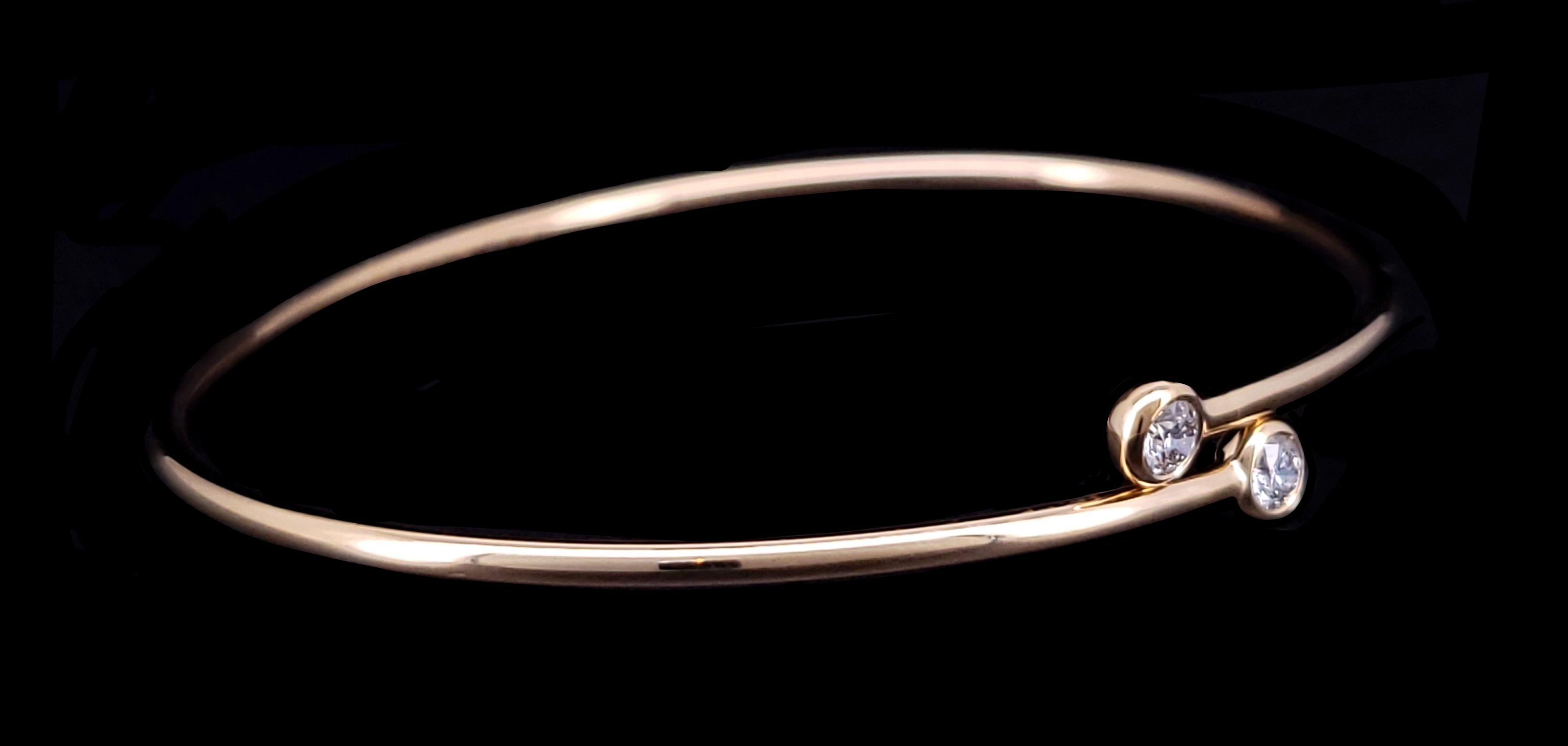 Tiffany& Co Elsa Peretti Hoop Bangle Bracelet
Material 18K Yellow Gold
Diamonds: .23ct
Diamond Clarity VVS
Color Grade E-F
Bracelet Fits wrist up to 6 1/4'' considered small to medium
Bracelet Weight: 3.1 gram
Condition Pre-owned, looks like