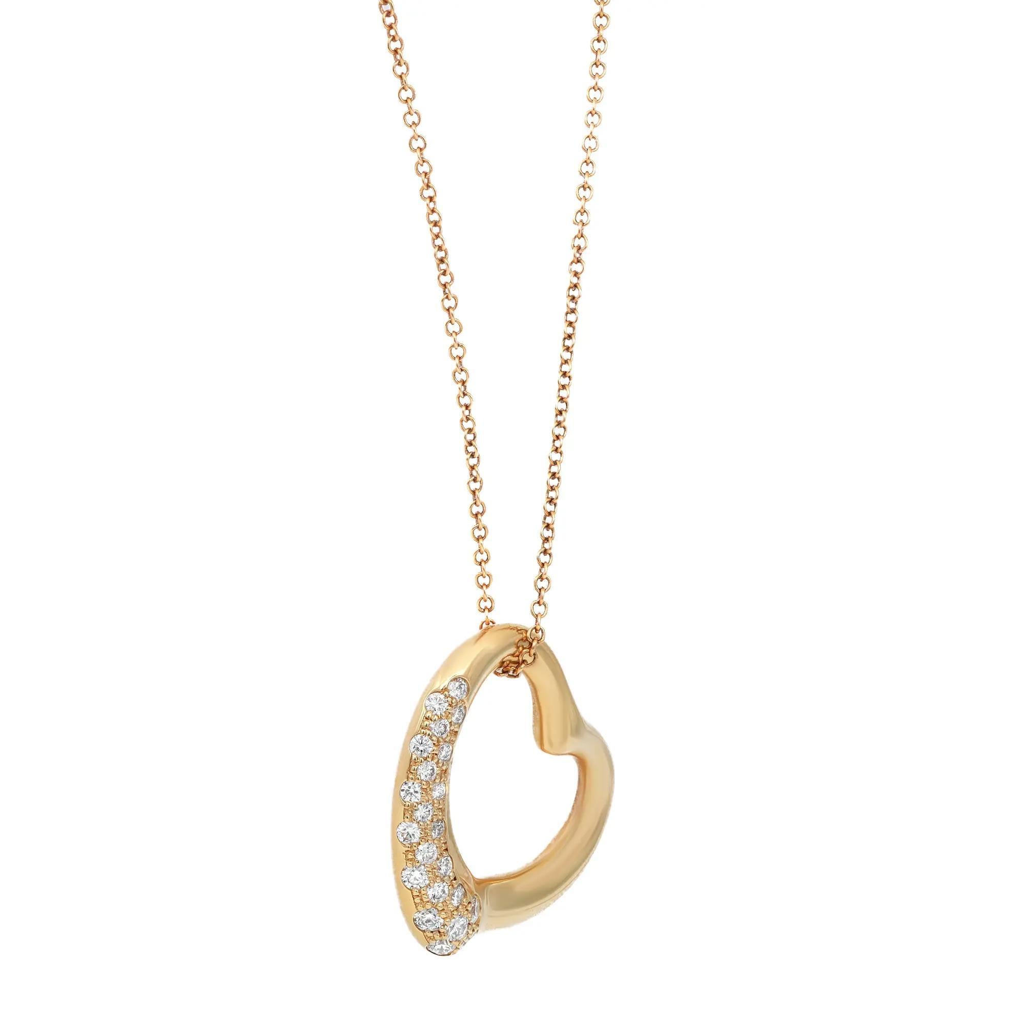 Tiffany & Co. Elsa Peretti open heart diamond pendant. This design celebrates the spirit of love. Shimmering diamonds accentuate the elegant curves of this pendant. Crafted in 18k yellow gold with pave set round brilliant cut diamonds weighing