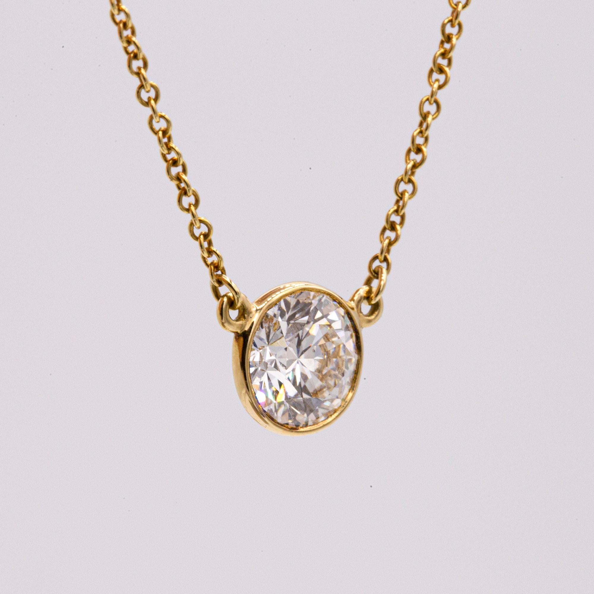 Vintage 18K Yellow Gold Tiffany & Co  Elsa Peretti bezel set diamond necklace with one
round brilliant diamond weighting 1.16CTW. The diamond is G in color and VS1 in clarity.
The chain measures 16 inches.