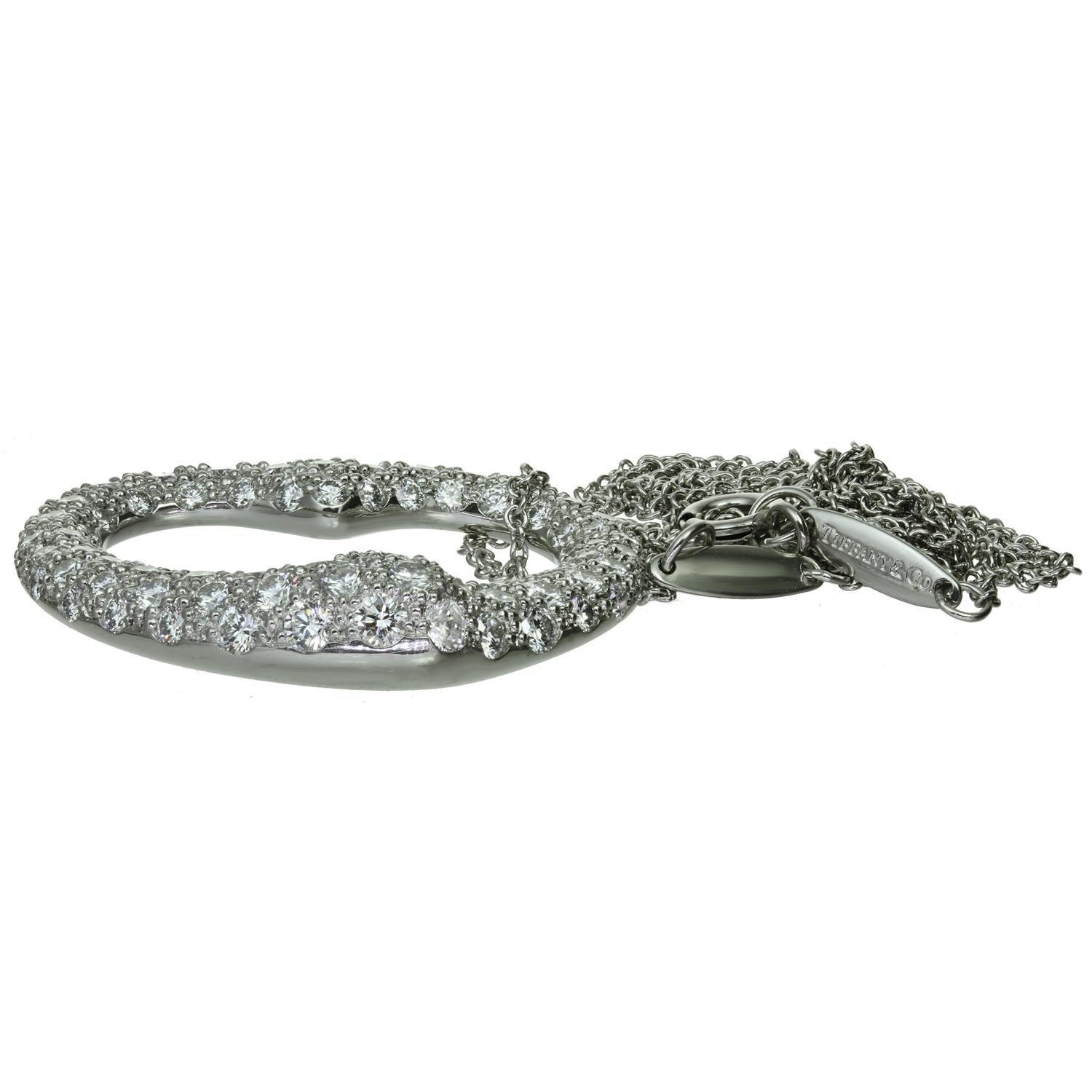 Ce magnifique collier emblématique de Tiffany & Co., conçu par Elsa Peretti, présente un pendentif en forme de cœur ouvert, réalisé en platine et serti de diamants ronds de taille F-G VVS1-VVS2 dont le poids est estimé à 2,0 carats. Complété par une