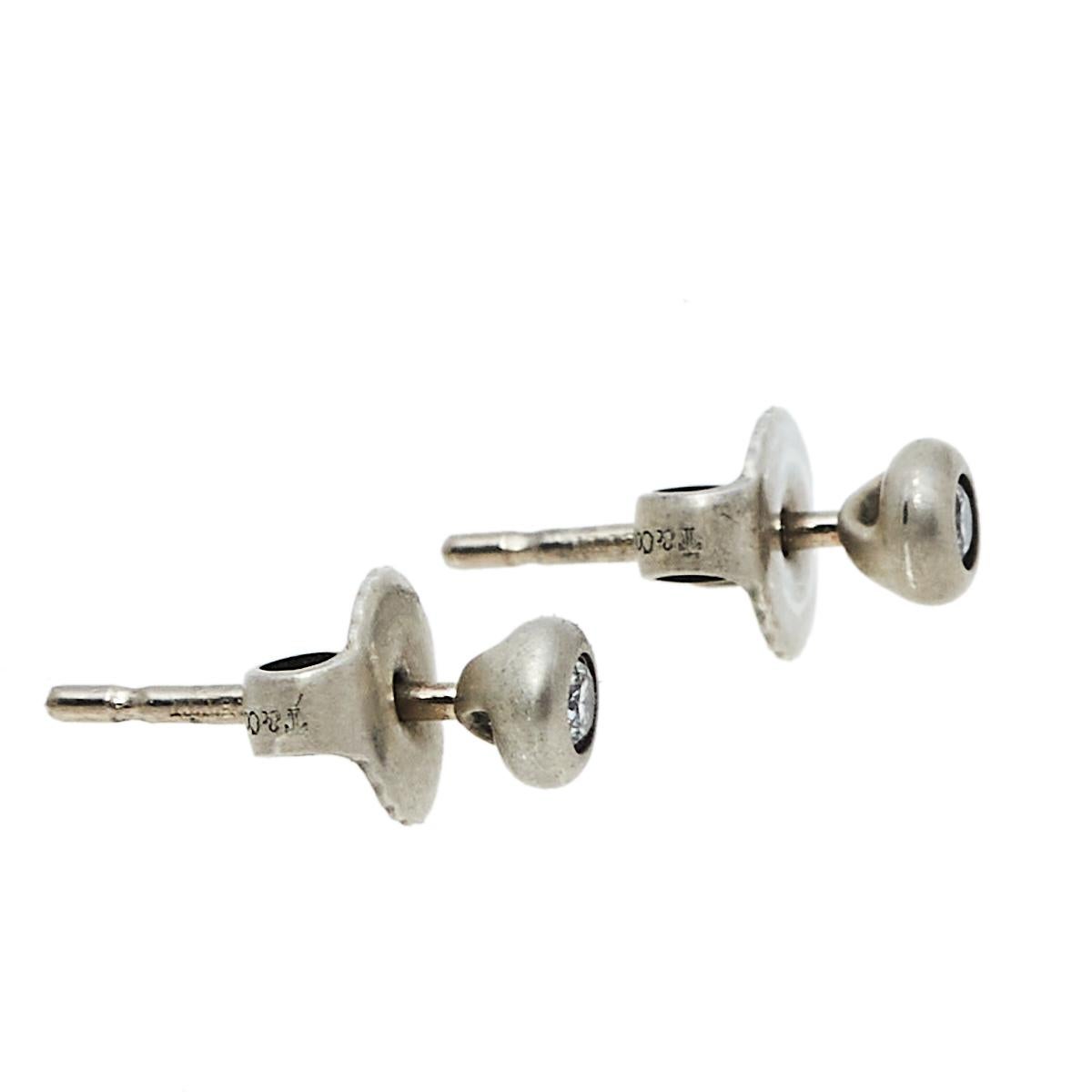 Take your new-season style up a notch with these Tiffany & Co. silver stud earrings. Crafted aesthetically with round diamond studs in the front and secured with push-back fasteners behind, these earrings will compliment all your outfits.

Includes:
