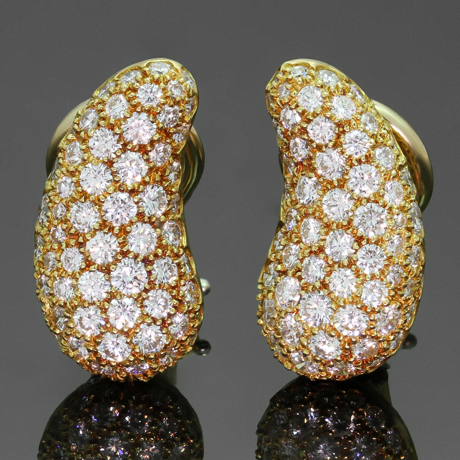 These gorgeous clip-on earrings were designed by Elsa Peretti for Tiffany & co. and feature the classic bean shape crafted in 18k yellow gold and set with brilliant-cut round F-G VVS1-VVS2 diamonds weighing an estimated 2.75 carats. Made in United