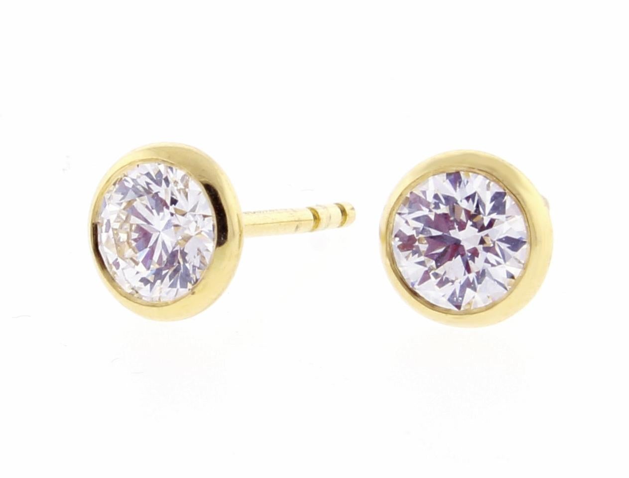 From Elsa Peretti for Tiffany & Co.'s,  a pair a bezel set diamond by the yard  diamond ear studs

♦ Designer / Hallmarks: Peretti T&C for Tiffany & Co #24500551
♦ Metal: 18 karat
♦ Gem stone: 2 Diamonds = 1.18 total carats H SI1  Triple Excellent